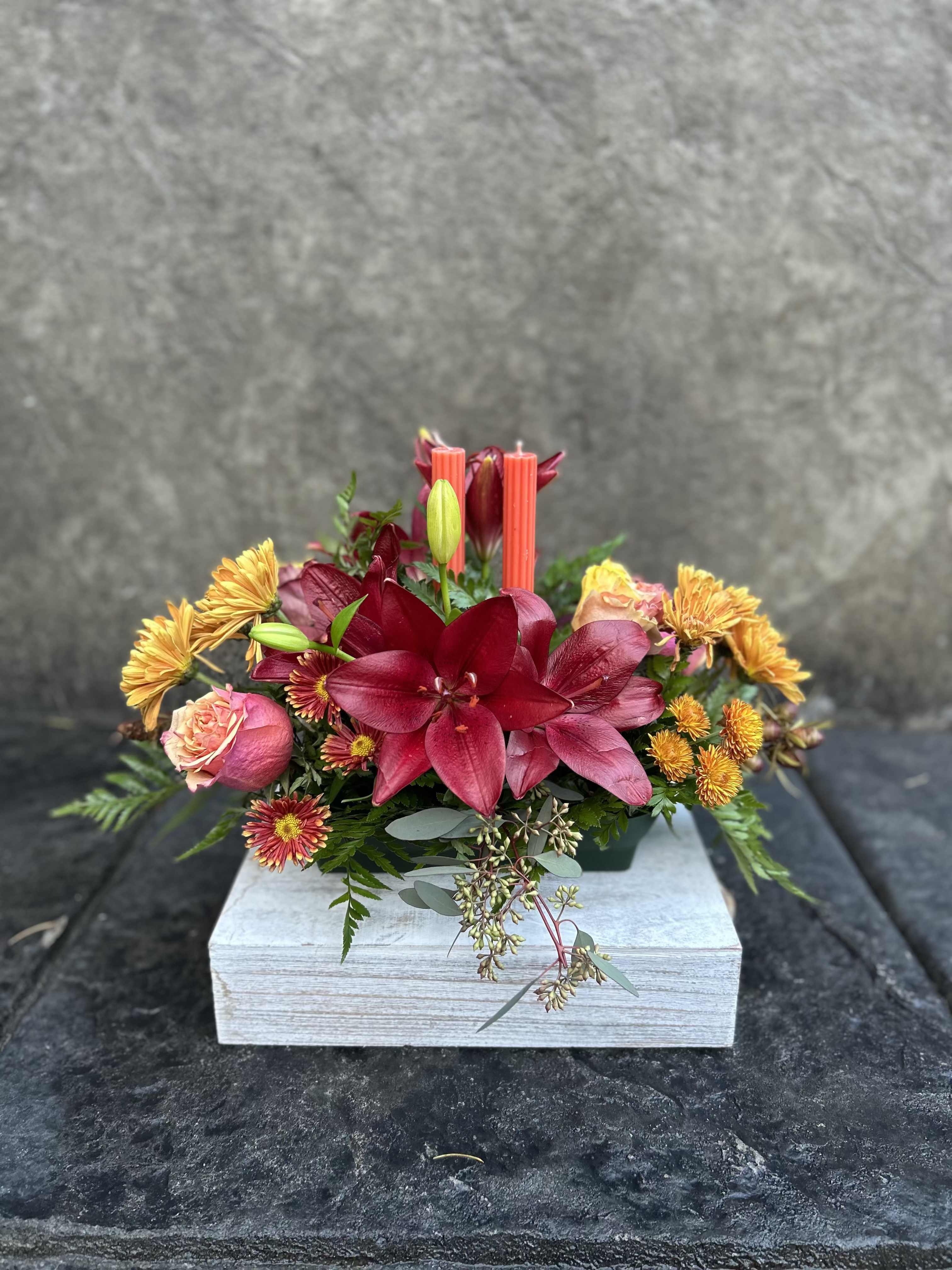 Center Piece - Burgundy Asiatic Lilies, roses, bronze chrysanthemums, daisies, seeded eucalyptus, two candles for your family dinner.   *Reasonable substitutions may be made due to floral availability. Will have overall look and theme.