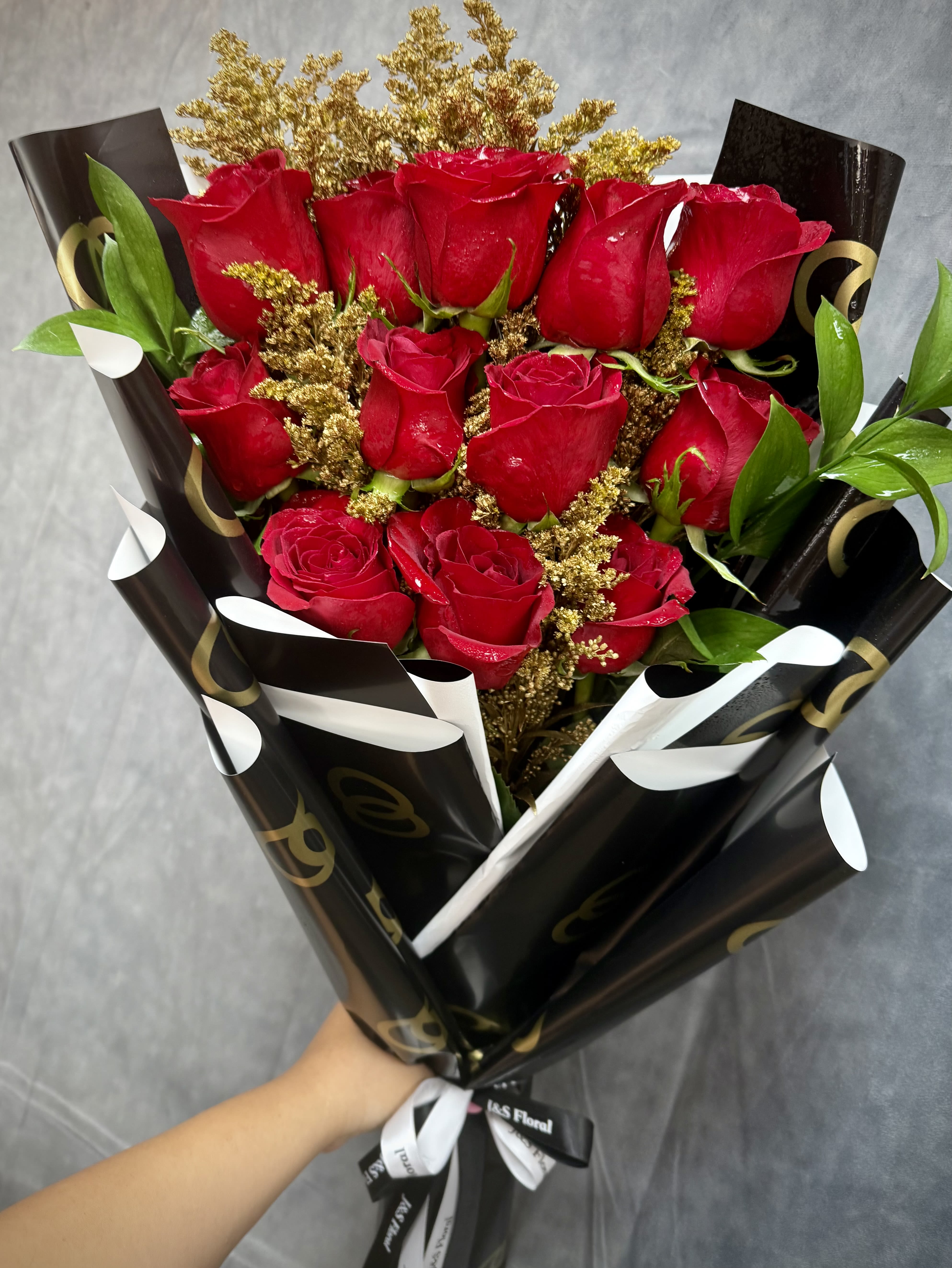 Golden Red Roses layered Bouquet  - We’re so excited to share this exclusive look at how we create our stunning Golden Red Roses Layered Bouquet! From carefully selecting the freshest roses to expertly wrapping them in our luxurious Chanel-inspired wrapping papers, every detail is crafted with elegance and care.  Available in 1 Dozen, 2 Dozen, or 3 Dozens, this bouquet is perfect for making a bold statement for any occasion.
