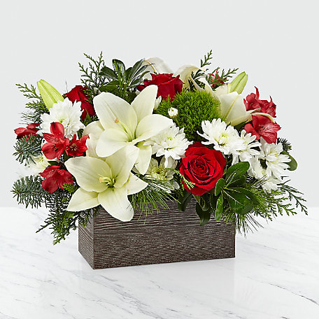  I'll Be Home Christmas - Nothing says happiness and joy more like coming home to the ones you love most. An artful collection of white cushion pompons and Asiatic lilies with contrasting red roses and alstroemeria makes those precious moments this season all the more special. They all arrive in a rustic, weathered wooden rectangular box.
