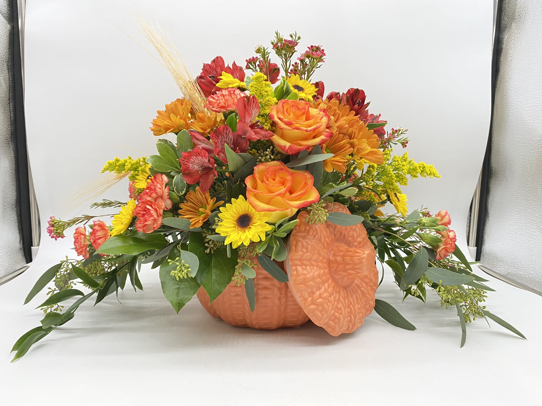 The Enchanted Centerpiece - A fresh mix of Fall Favorites adorned in a keepsake ceramic pumpkin with lid.