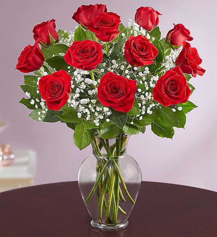 Classic Red Dozen Roses  - Elevate any occasion with the timeless beauty of our exquisite red roses. Bursting with vibrant color and delicate fragrance, these roses are the epitome of romance and passion. Whether it's to convey love, celebrate an anniversary, or simply brighten someone's day, our red roses are the perfect choice for expressing heartfelt emotions.