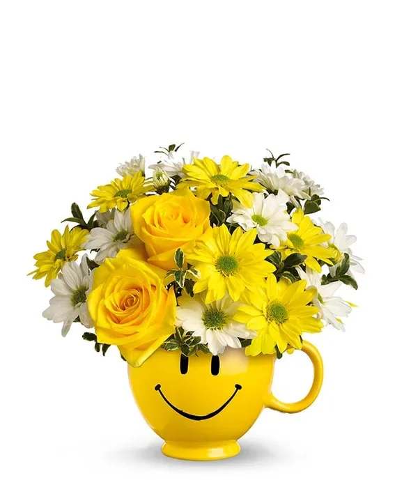 Happy Face Mug - Sending someone a smile is as easy and sending them this smiling flower bouquet. The Happy Face Mug Bouquet is the perfect give to turn someone's day around. This yellow happy face mug is overflowing with seasonal yellow flowers such as daisies and roses, accompanied by white daisies sprinkled in. The best part is that the mug, after a good washing, is reusable, this really will bring them a smile day after day. Perfect for morning coffee or afternoon tea, this is a yellow treat is worth giving.