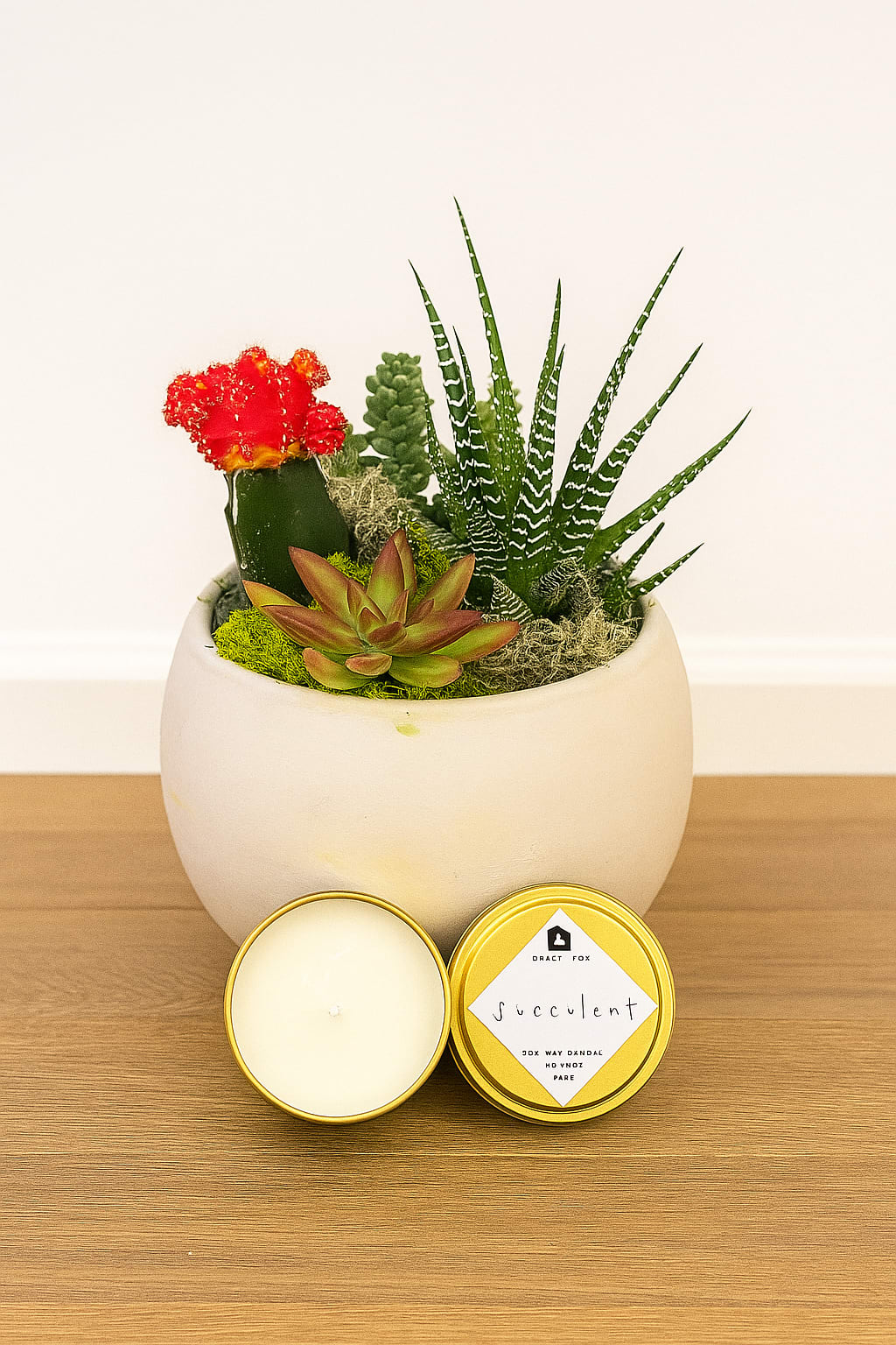 Urban Garden - Fresh and modern, Urban Garden pairs a vibrant succulent and cactus collection with a hand-poured soy candle for a thoughtful, stylish gift. Designed in a neutral ceramic pot with natural moss accents, this piece adds a touch of greenery and calm to any space. Perfect for home décor, offices, or gifting with contemporary flair.  Modern. Fresh. Designed in San Francisco by Polk Street Florist.