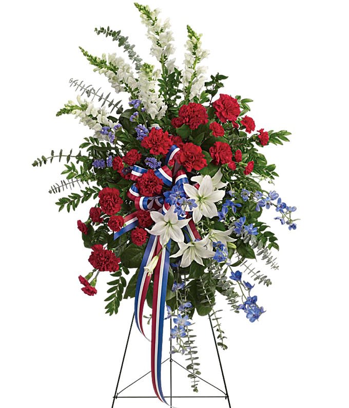 Patriotic Standing Spray - Sparkling like an Independence Day fireworks display, a striking red, white and blue spray stands tall, proud and patriotic. Bearing the colors of our nation's flag, it's a grand and fitting tribute to members of the military and American heroes.