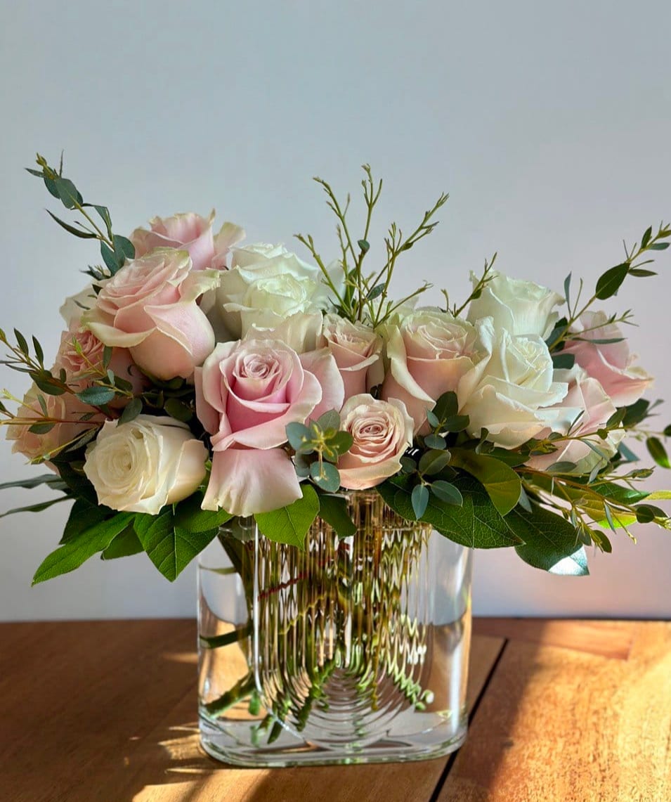 Cotton Candy - Surprise her with not one but fourteen gorgeous light pink roses and eight white roses in a designer rectangular clear glass vase. Life will be twice as rosy for you both - all week long. That's a good gift for a loved one.