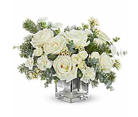 Artic Blooms Bouquet - Arctic Blooms Bouquet captures winter's serene beauty with snowy white roses, soft winter greens, and seasonal accents in a chic silver cube. A stunning Christmas or winter gift to brighten the season. Arctic Blooms Bouquet includes white roses, white spray roses, white carnations, white miniature carnations, white waxflower, spiral eucalyptus, and noble fir in a silver glass cube