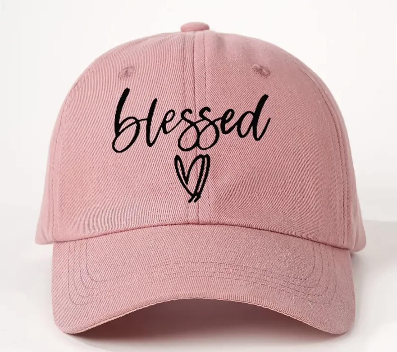 Blessed Heart Christian Cap – Pink Faith Hat - This soft pink cap is embroidered with “Blessed” in a hand-lettered script and accented with a sweet heart. A casual yet powerful statement of gratitude, this cap is ideal for everyday wear, prayer walks, or gifting to someone special.