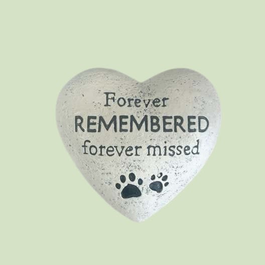  Forever Remembered Pet Memorial Heart - Honor the memory of a beloved pet with our Forever Remembered Pet Memorial Heart. Crafted from durable stone-like resin, this keepsake features engraved lettering that reads “Forever Remembered, Forever Missed” alongside two paw prints — symbolizing the lasting footprints left on your heart.  This timeless piece makes a thoughtful sympathy gift for pet lovers, a peaceful addition to a memorial garden, or a comforting keepsake to display in the home.   Details: 	•	Measures approximately 6” wide 	•	Made of weather-resistant resin 	•	Suitable for indoor or outdoor display 	•	Each piece arrives beautifully packaged and ready for gifting