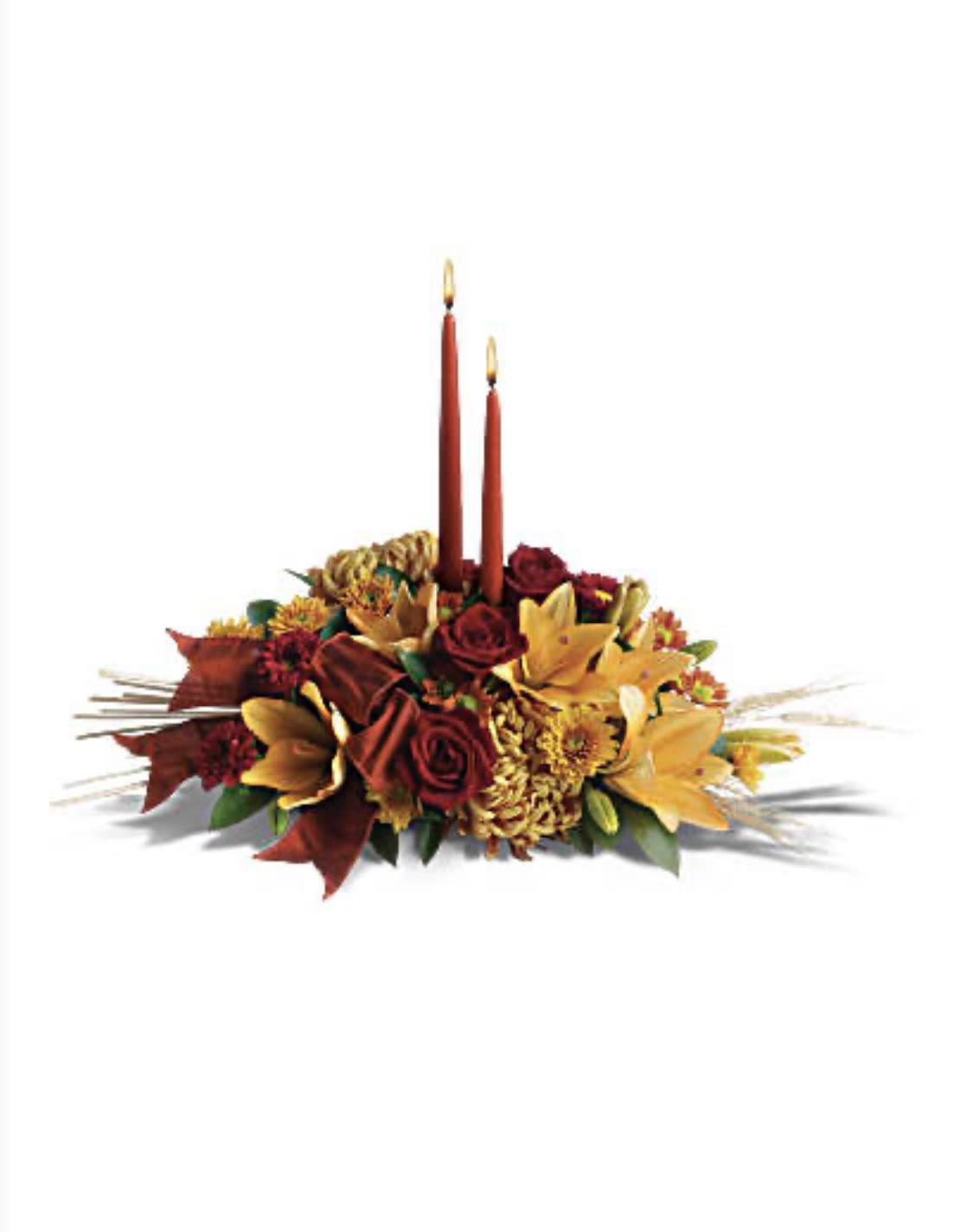 Graceful Glow Centerpiece - Add a graceful glow to your Thanksgiving dinner table or fall-decorated foyer with this warm, seasonal arrangement. Lilies, mums and asters are accented with sprays of wheat below glowing taper candles.