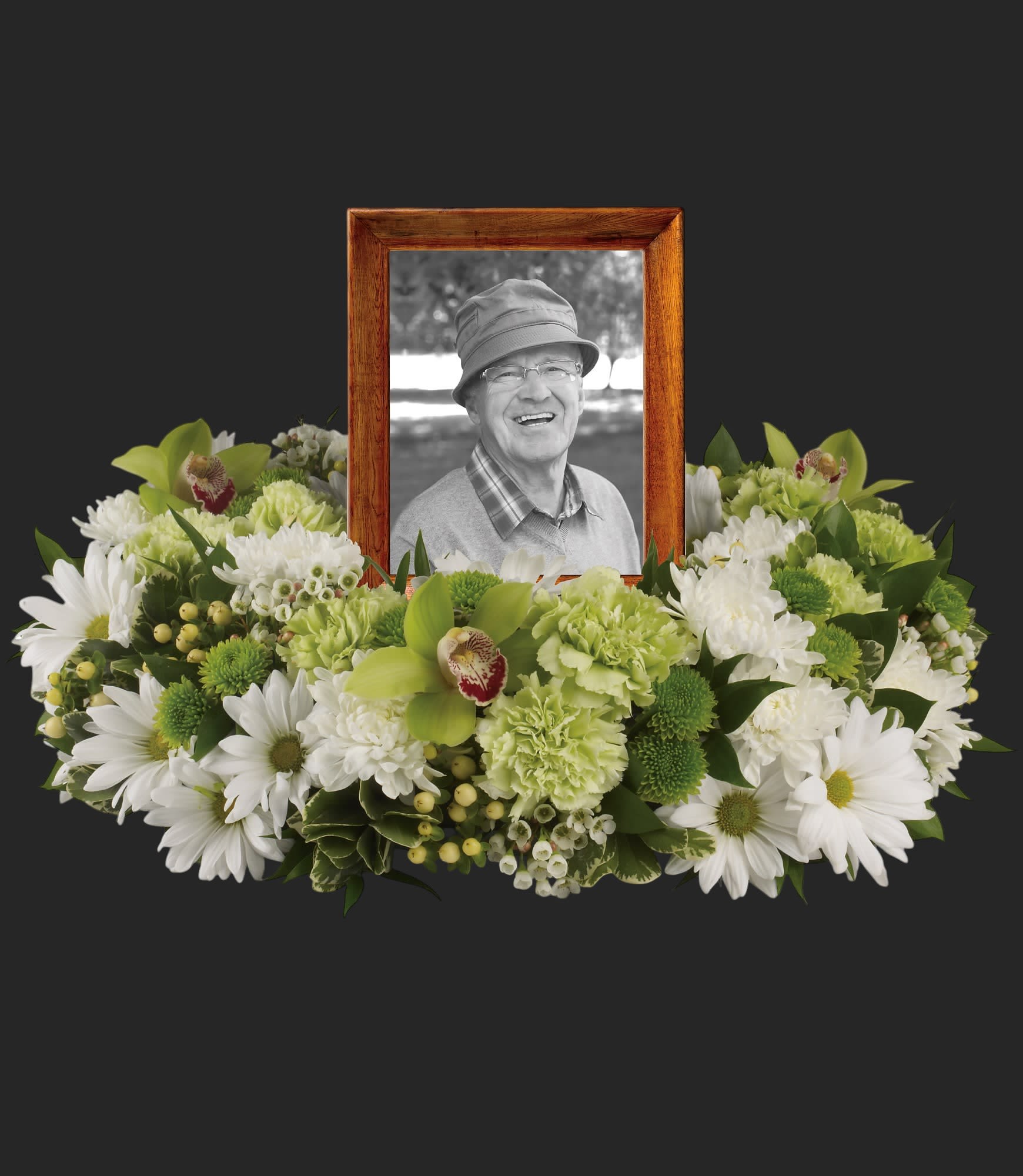 Garden Wreath by Teleflora - An exquisite round wreath with blooms inspired by the lasting impressions a loved one makes on our lives. Surround a treasured photograph, poem or other dear memento with sweet, green carnations, white and green chrysanthemums and the special beauty of green cymbidium orchids.    This luxurious wreath includes flowers such as carnations, chrysanthemums, silky green cymbidium orchid blossoms and variegated greenery. Please note: Arrangement does not include picture frame.    Approximately 20&quot; W x 14&quot; H    Orientation: One-Sided        As Shown : T255-1A    