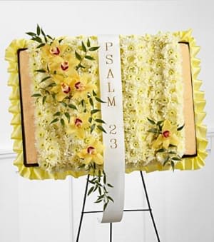 The FTD® Taken Too Soon™ Bible Easel - The FTD® Taken Too Soon™ Bible Easel is a beautiful way to reaffirm the faith of the family and friends at their final tribute. Yellow cymbidium orchids and white chrysanthemums are delicately arranged atop an open styrene portfolio edged with a yellow satin ribbon and accented with a white ribbon which reads, &quot;Psalm 23&quot;, in gold metallic lettering, to create a wonderful display that offers comfort and beauty at their memorial service. Approximately 18&quot;H x 27&quot;W. Your purchase includes a complimentary personalized gift message.