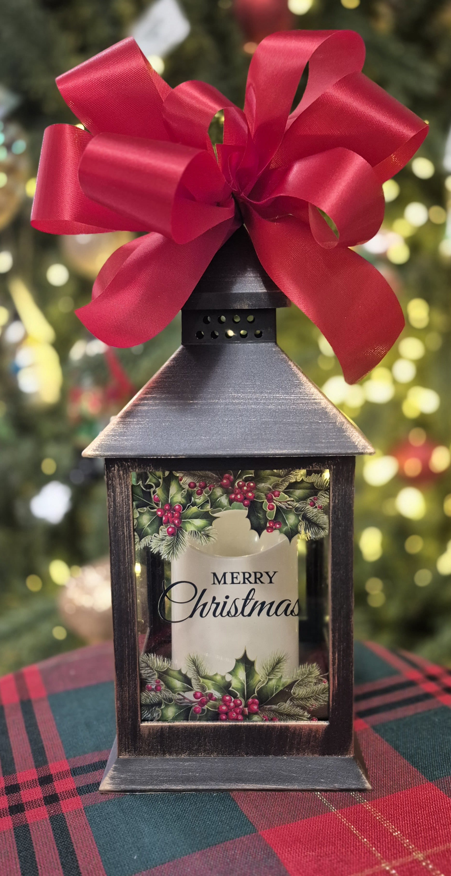 Merry Christmas Lighted Lantern - Message on the lighted lantern reads &quot;Merry Christmas&quot;. Great gift for a child or adult, what a wonderful gift to receive and be able to use for many years to come. 9&quot; H Comes with 3 triple A batteries and a bow.