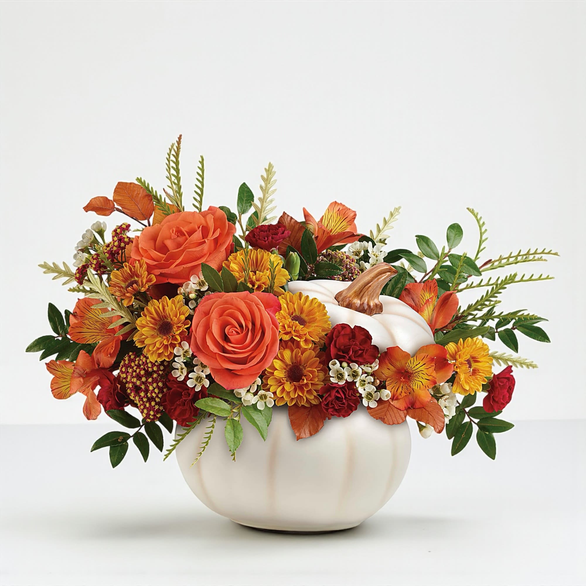 Enchanted Harvest Bouquet - Welcome the warmth of the season with our **Enchanted Harvest Bouquet**—a stunning fall arrangement designed in a white ceramic pumpkin that brings both beauty and charm to any space. Overflowing with autumn's richest tones, this bouquet blends rustic textures with elegant seasonal blooms for the perfect centerpiece or gift across Greater Fort Lauderdale.  **Featuring:**  * A vibrant mix of orange roses, alstroemeria, miniature maroon carnations, yellow Viking daisies, and white waxflower, all hand-arranged with preserved oak leaves, red yarrow, and autumn foliage. * Designed in a keepsake white ceramic pumpkin, ideal for festive tables, countertops, or entryway décor. * All-around orientation, professionally styled to look stunning from every angle—perfect for centerpieces or open spaces. * Hand-delivered by your local Fort Lauderdale florist, DGM Flowers, with expert care and attention. * Tip: Keep out of direct sun and away from pets. Refresh water daily for longer-lasting beauty.  *Size &amp; Dimensions:*  * Standard: approx. 12.5″ H × 17″ W * Deluxe: approx. 12.5″ H × 17″ W, with enhanced floral fullness * Premium: approx. 12.5″ H × 17″ W, featuring the highest bloom count for a bold seasonal impact  **Perfect For:** Fall gatherings, thank-you gestures, or seasonal home décor—this bouquet brings cozy, upscale harvest vibes to homes and offices across Greater Fort Lauderdale.  