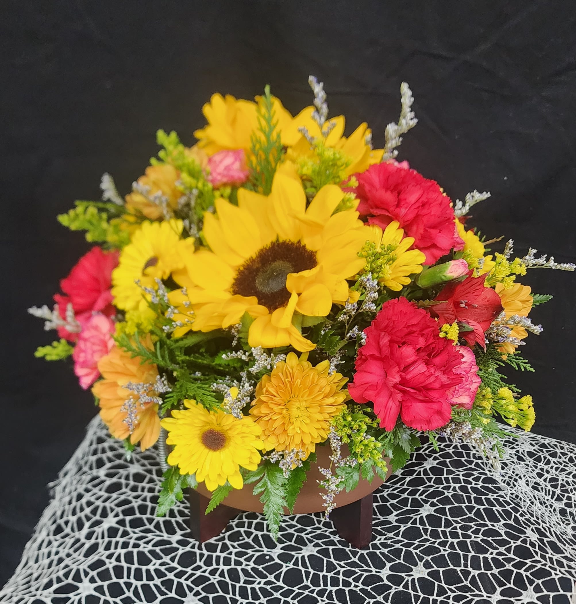 Mountain Traditions - Nothing completes your Thanksgiving table better than a beautiful floral centerpiece! This fall centerpiece comes in an elegant copper planter and filled to the brim with sunflowers, fall mums, carnations and more. (fall mums and carnation colors may vary due to availability) Deluxe and Premium come with roses. 