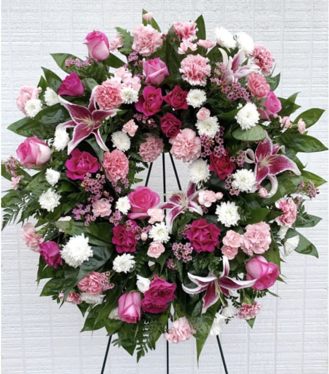 Pink and Green Funeral Wreath - Local Same Day &amp; Express Flower Delivery Our Pink and Green Sympathy Wreath is a large wreath designed with lilies, roses, carnations, mums, and waxflower, accented with fresh greenery. 