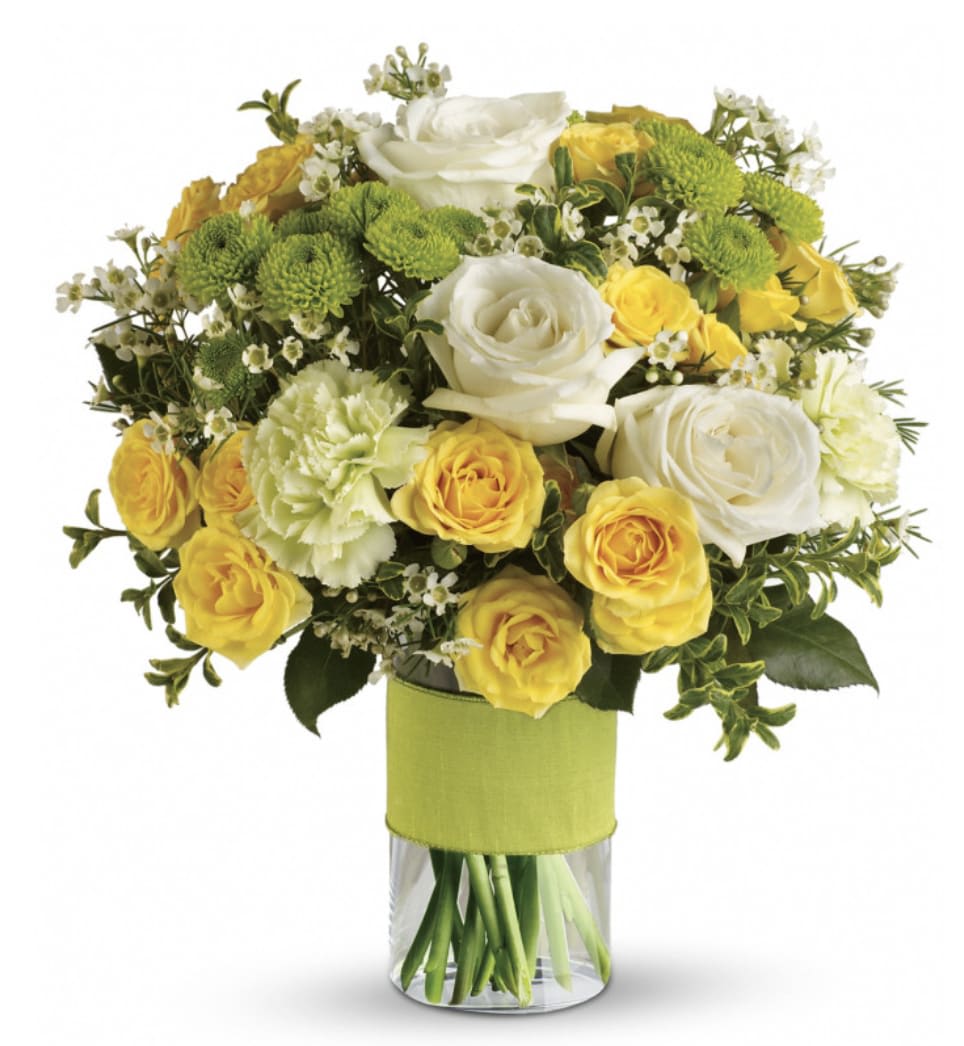Sweet Smiles Bouquet - Bring a smile to their face with the Sweet Smiles Bouquet! Featuring white roses, yellow spray roses, green carnations, green button spray chrysanthemums and white waxflower accented with assorted greenery and expertly designed in a glass cylinder vase.