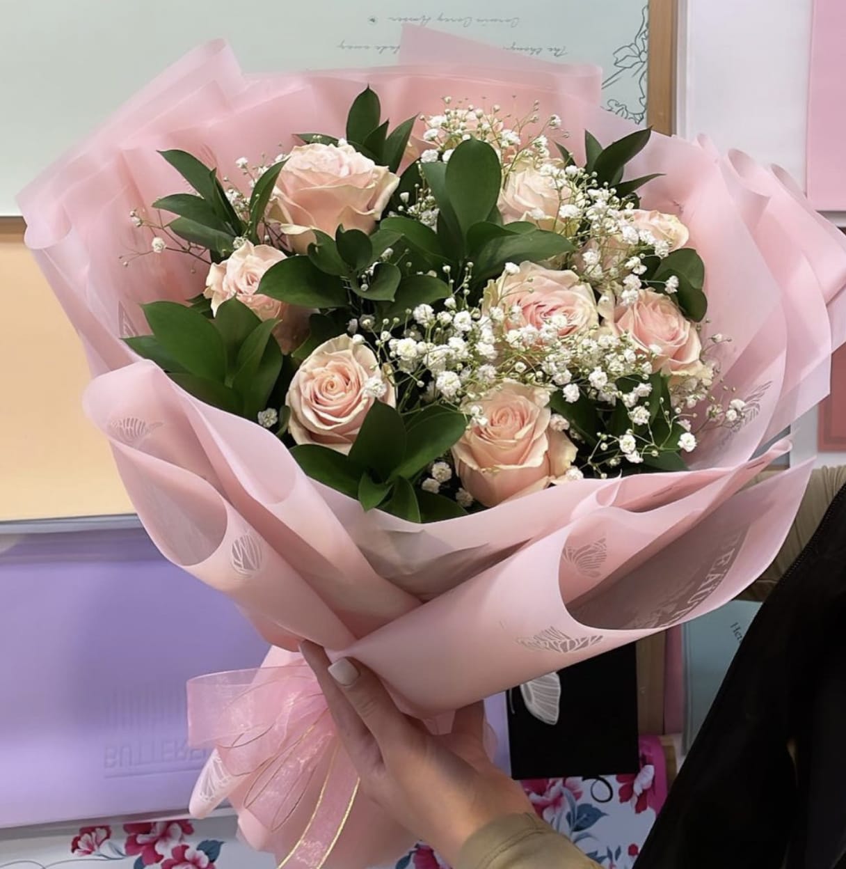 Pink Dreams Bouquet - Introducing our exquisite bouquet of pink roses, delicately held by a woman, this image captures the essence of elegance and beauty. The soft pink hues of the roses symbolize grace and admiration, making it the perfect gift for any occasion. Handcrafted with love and care, each rose is carefully selected to ensure the highest quality and freshness. Whether you're looking to express your love, appreciation, or simply brighten someone's day, this stunning bouquet is sure to leave a lasting impression.