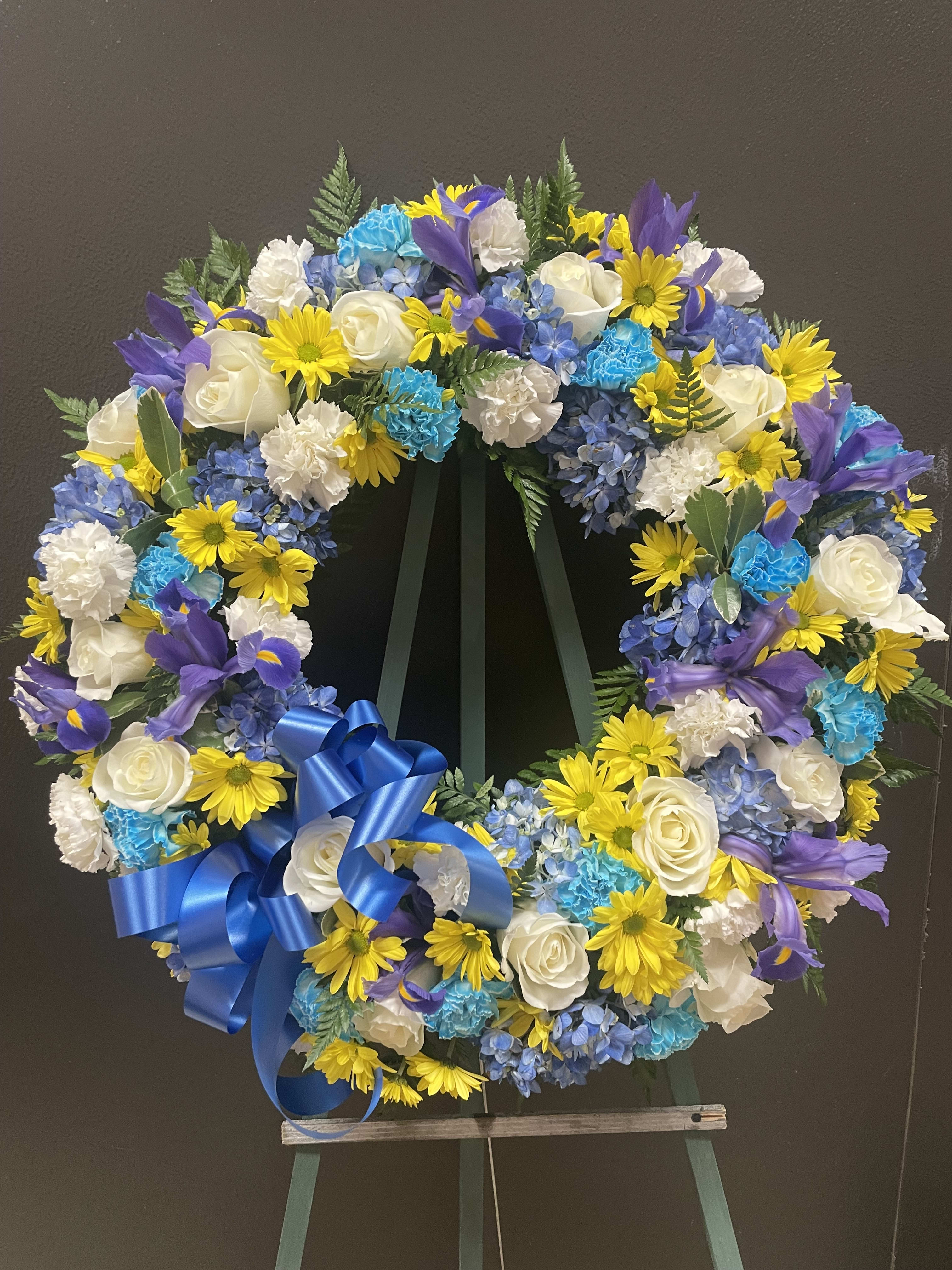 Blue yellow and white wreath  (FW20) - This wreath made with Blue and white carnations, yellow daisies , Irish, and white rosés.