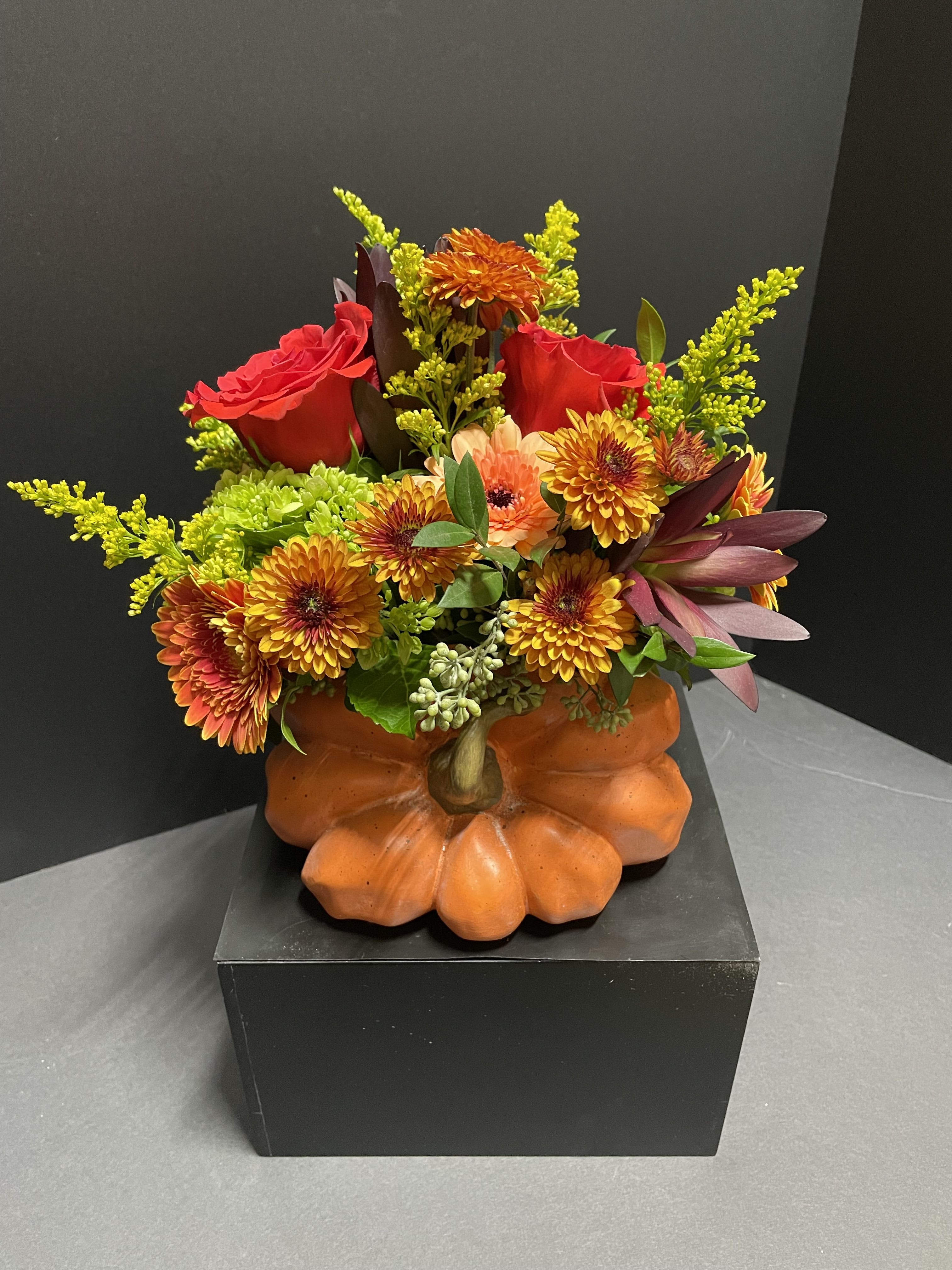 Pumpkin Spice Blooms - A mix of beautiful fall colored blooms in a contemporary keepsake ceramic pumpkin container.  Perfect for the fall lover in your life!