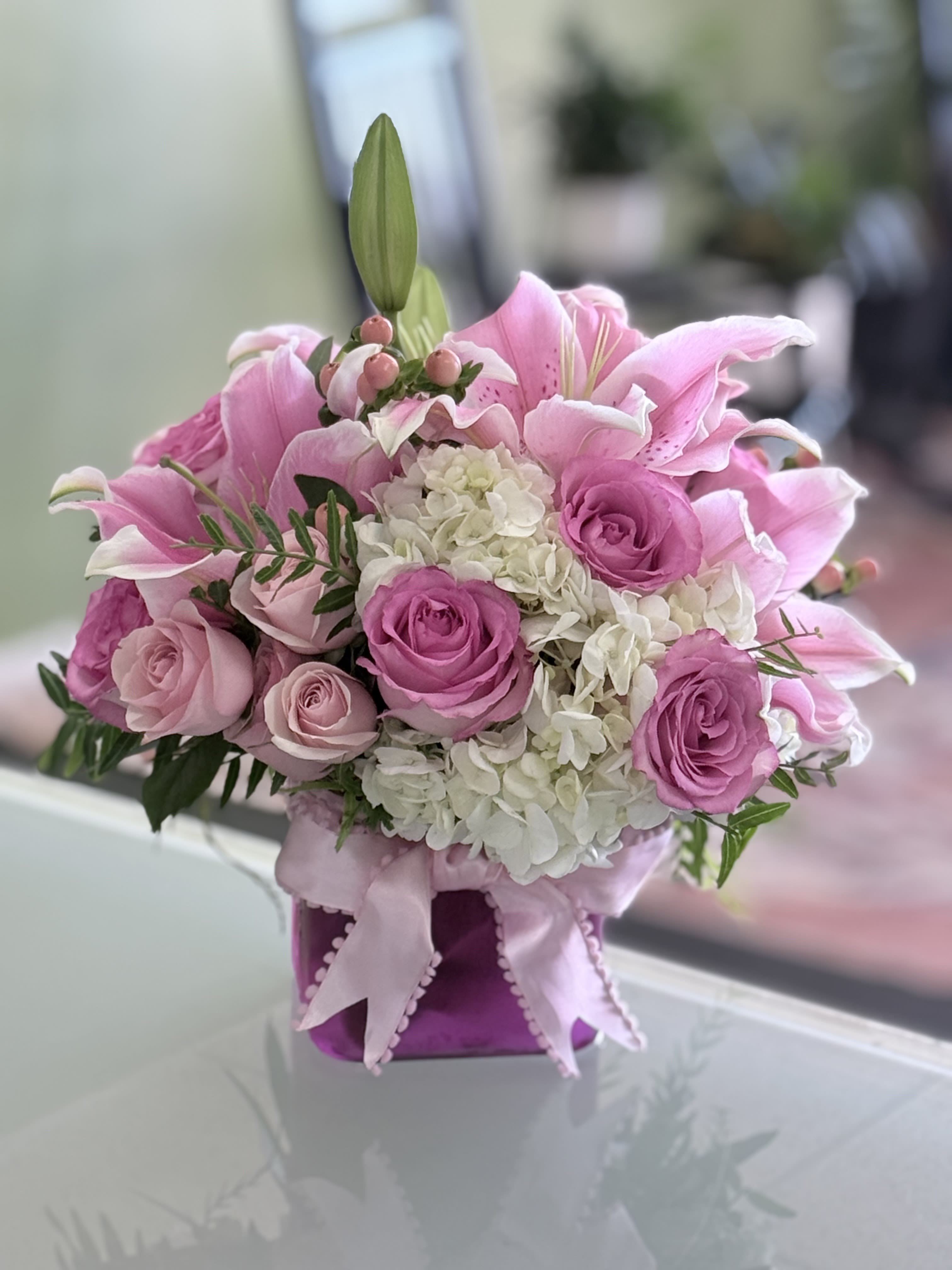 Magic - Pink Oriental Lilly’s, white Hydrangeas, Pink Roses, Light Pink Spray Roses, Coffee Beans. 