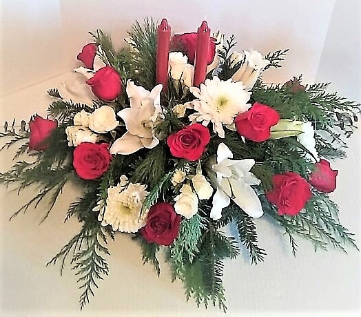 Premium Fragrant Centerpiece - Send this large beautiful centerpiece of premium large white Lilies and a full dozen red roses,jumbo chrysanthemums,and miniature white roses immersed in a field of fragrant Christmas greenery with candles for the perfect Christmas gift 