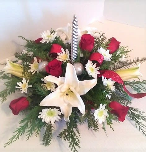 Happy Holiday Centerpiece - Red roses,white lilies,and white chrysanthemums with fragrant greenery and a candle for a truly traditional look for the table.