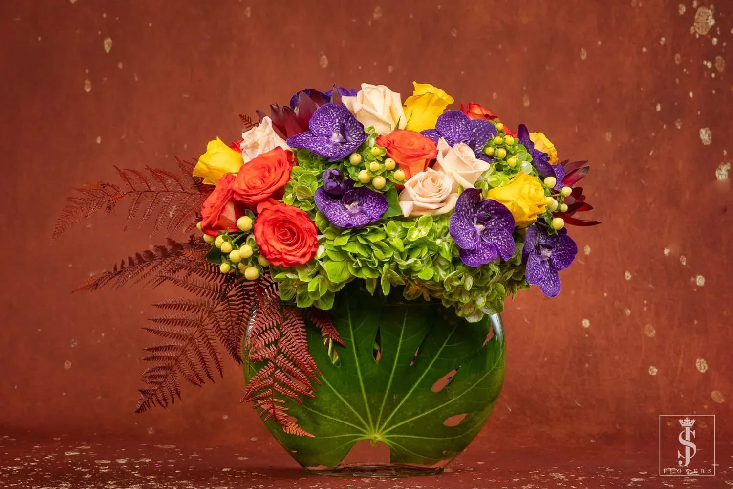 Simply Thankful  - This Lush Modern Arrangement bouquet is bursting with colors – including fall yellows, oranges, purples, and green. Simply Thankful is filled with beautiful, lush roses, and Orchids.