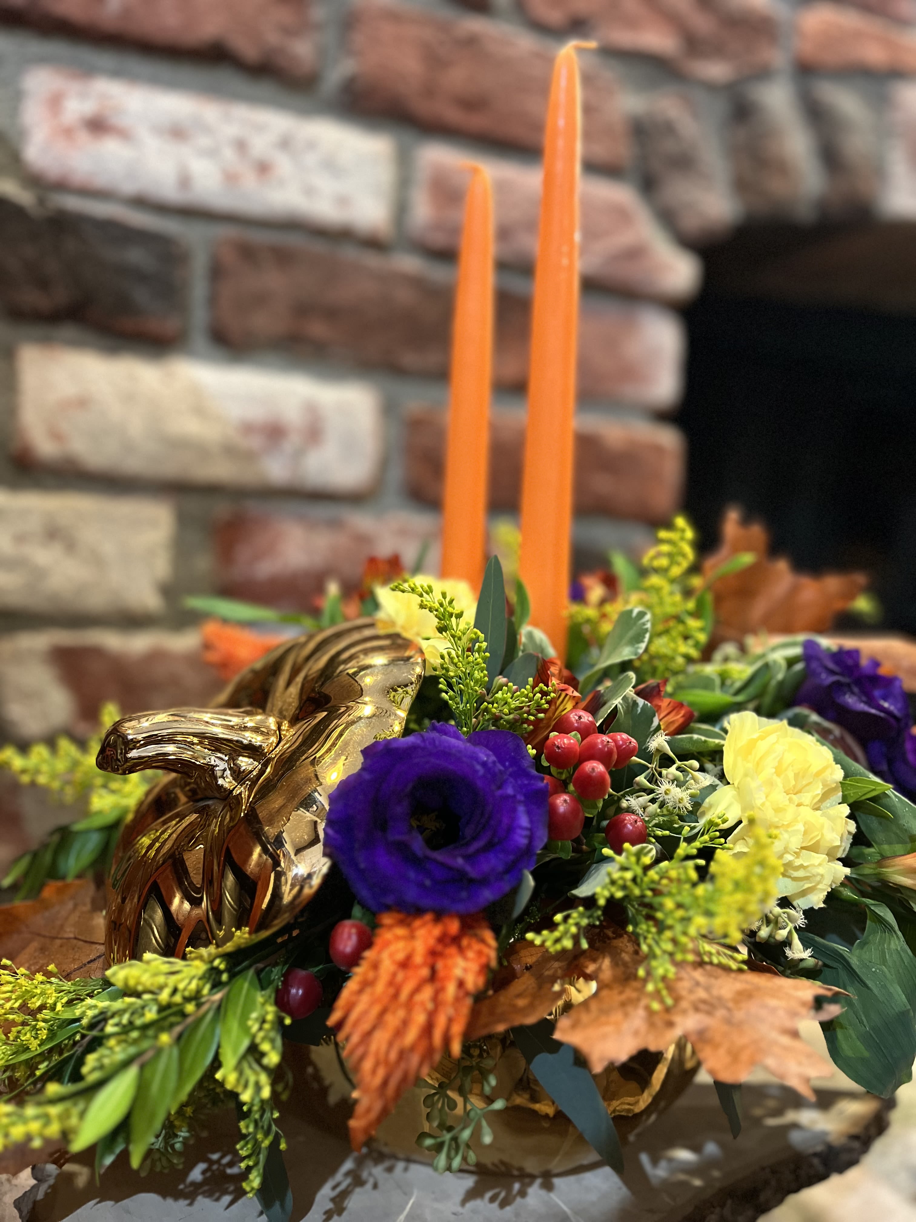 Golden Pumpkin Garden  - This golden pumpkin arrangement with it's deep purple lisianthus, orange celosia, red hypericum berries, and solid aster is the perfect way to bring the spirit of autumn indoors, with a rustic elegance that feels both timeless and inviting.  