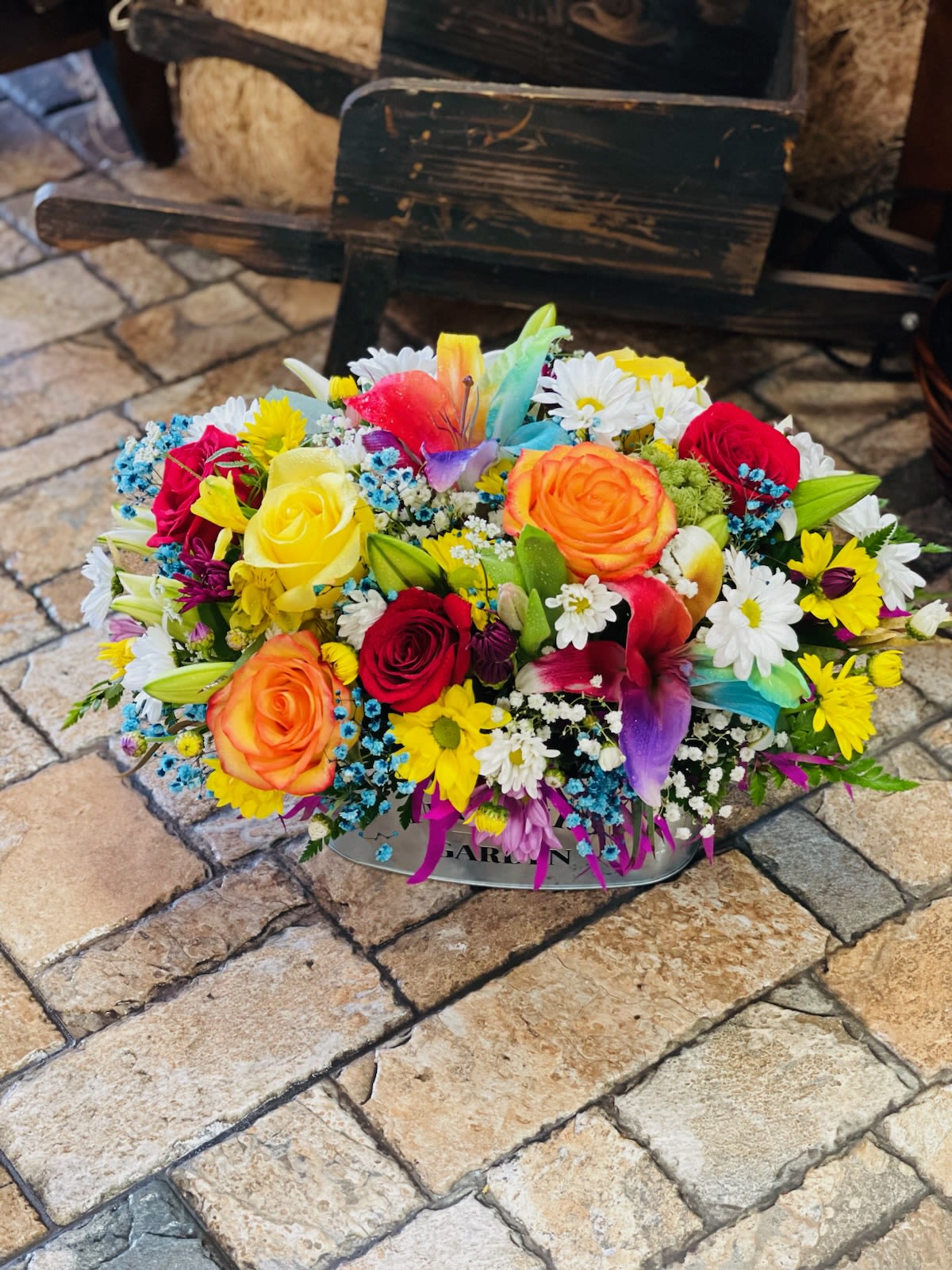 Technicolor Dream Basket - Our Technicolor Dream arrangement brings the rainbow to life! Featuring stunning lilies, roses, and more, all perfectly presented in a chic silver basket. Flowers and colors may vary.
