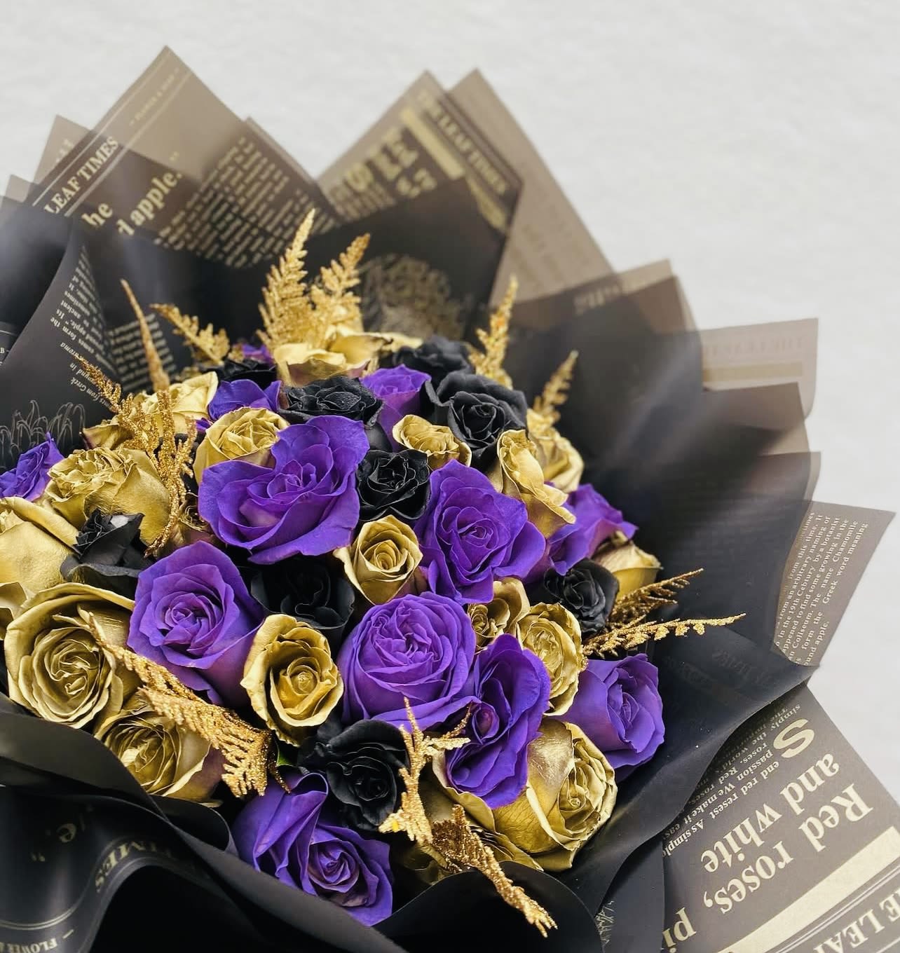 Royal Enigma - Unveil the allure of elegance with our Royal Enigma bouquet. Featuring deep purple blooms, striking black accents, and shimmering touches of gold, this arrangement exudes sophistication and mystery. Perfectly crafted to create a bold and unforgettable impression, it’s ideal for special occasions, luxurious gifts, or to make a statement in any space. Whether you’re celebrating milestones, honoring someone special, or simply indulging in extraordinary beauty, Royal Enigma combines rich tones and exquisite textures for a bouquet as unique as the moment itself.