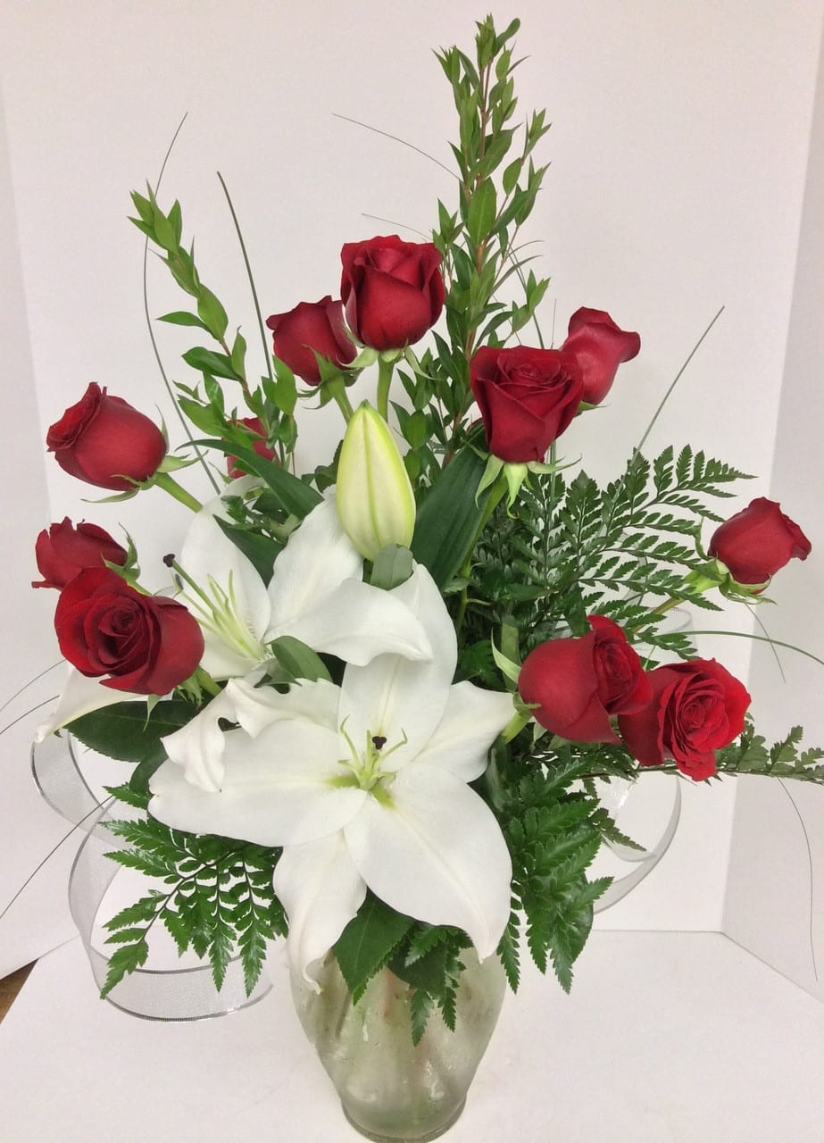 From This Moment - Send your love, appreciation, congratulations, or support with this striking bouquet of rich red roses and elegant white lilies designed and delivered in a tasteful glass vase. Popular for love, romance, or any heartfelt expression.