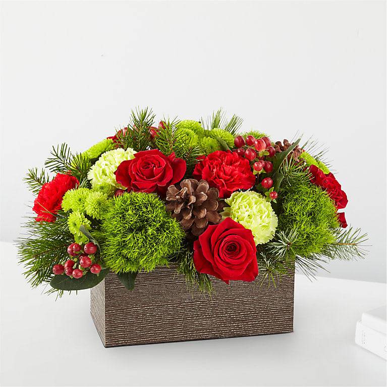 Bundled Up Bouquet - BUNDLED UP BOUQUET Filled with the essence of warmth and coziness, the Bundled Up Bouquet is the perfect gift for a loved one or centerpiece for your own holiday gathering.   DETAILS The Deluxe Bouquet is approximately 11&quot;H x 15&quot;W. Designed by florists, ready to display. For long–lasting blooms, add water daily.  &nbsp;   Pet Safety Precautions: This bouquet or plant may include flowers and foliage that are known to be toxic to pets. To keep them safe, be sure to keep this arrangement out of your pet's reach. BLOOM DETAILS Carnation Rose