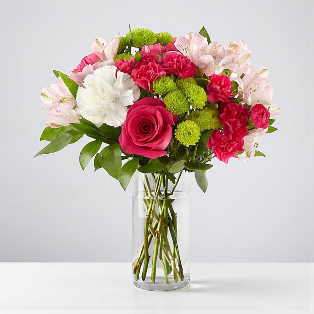 Sweet &amp; Pretty Bouquet - The Sweet &amp; Pretty Bouquet by DGM Flowers | Fort Lauderdale Florist is a beautiful arrangement. The true beauty of this bouquet is within the sweet colors of the flowers. An array of hot pink roses, pale pink alstroemeria and more are set in a glass cylinder vase, making a wonderful gift to light up the face of its recipient.  DETAILS The Deluxe Bouquet is approximately 15&quot;H x 15&quot;W. For long–lasting blooms, replace the water daily. We suggest trimming the stems every couple days. BLOOM DETAILS Carnation Rose