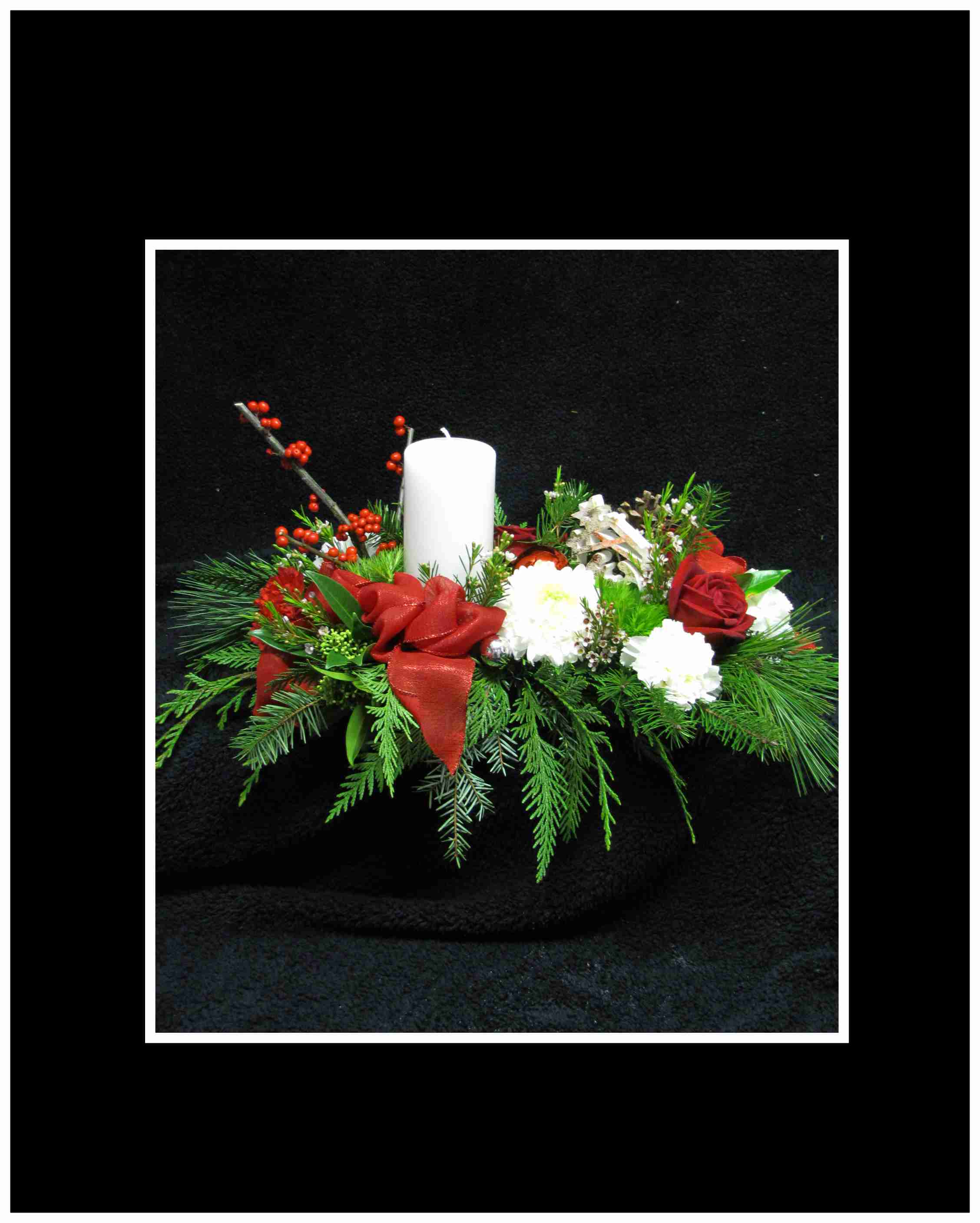 Christmas Memories Arrangement - ;A wonderful tablearrangement;with red roses, carnations, disbud mums, pine cones, ilex berries, a keepsake ornament, Christmas stem balls, and bows, with a pillar candle and holder, Christmas greenery.  approximately20 H&quot; X 12 W