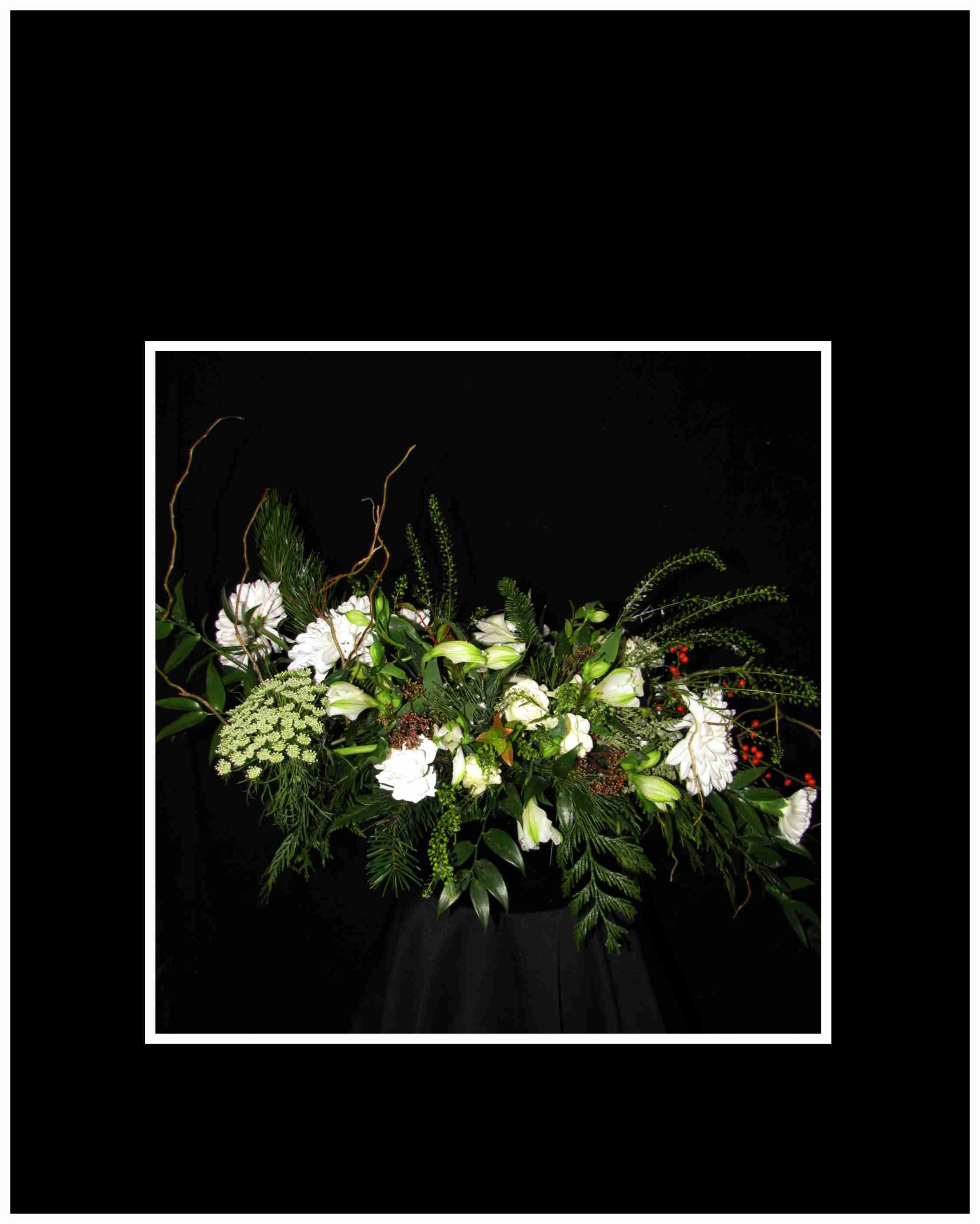White Christmas Center Piece - High style Christmas this wonderful center piece that includes White spray Roses, white alstromeria, disbuds carnations with silver accents and a votive candle Always fresh    Approximately: 18&quot; long by 15&quot; high