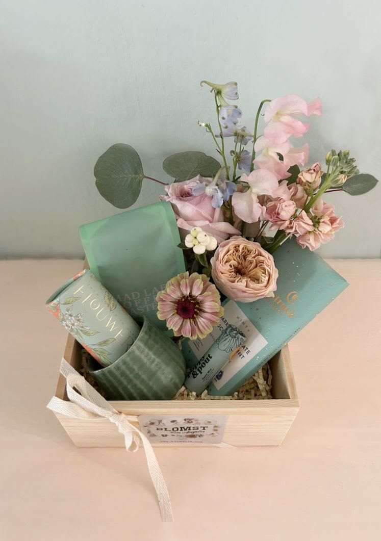 California Cozy Box - Beautiful gift box with luxe goods in the beautiful color of light green. Perfect for all occasions. Ready for hand delivery in LA.  LA made luxe coffee from Madlab Coffee roasters Moonstruck Artisan mint chocolate Poppy and Pout Sweet Mint Natural lip balm Orange blossom cocktail cubes Ceramic mini coffee mug Mini arrangement of eclectic Blomst flowers