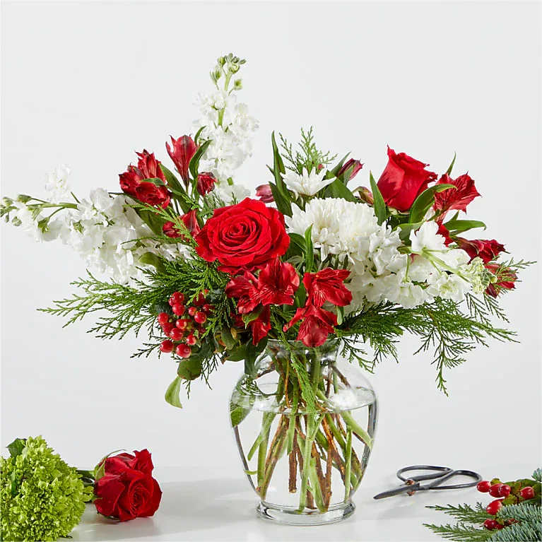 Merry Moments - Lovely vase filled with red and white blooms, with fresh winter greens.