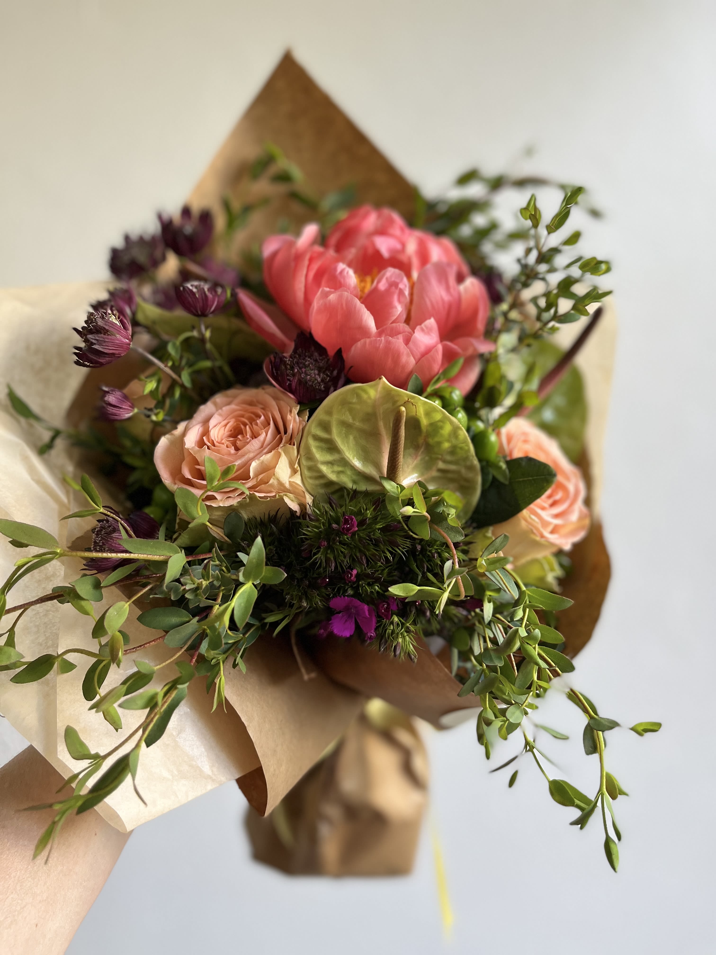 Ramo Delicado - A beautiful soft toned hand bouquet with roses, anthurium, astrantia, eucalyptus, dianthus and Peonies (upon availability- if not it will be substituted with a Garden Rose) 