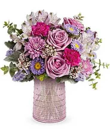 Teleflora Garden Medley - A sentimental arrangement of pinks and lavenders in a cylinder vase.