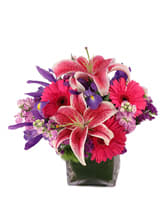 Pink-n-Flirty - Vibrant hot pink gerberas and stargazer lilies with accents of purple in a cube - sure to get her attention!  