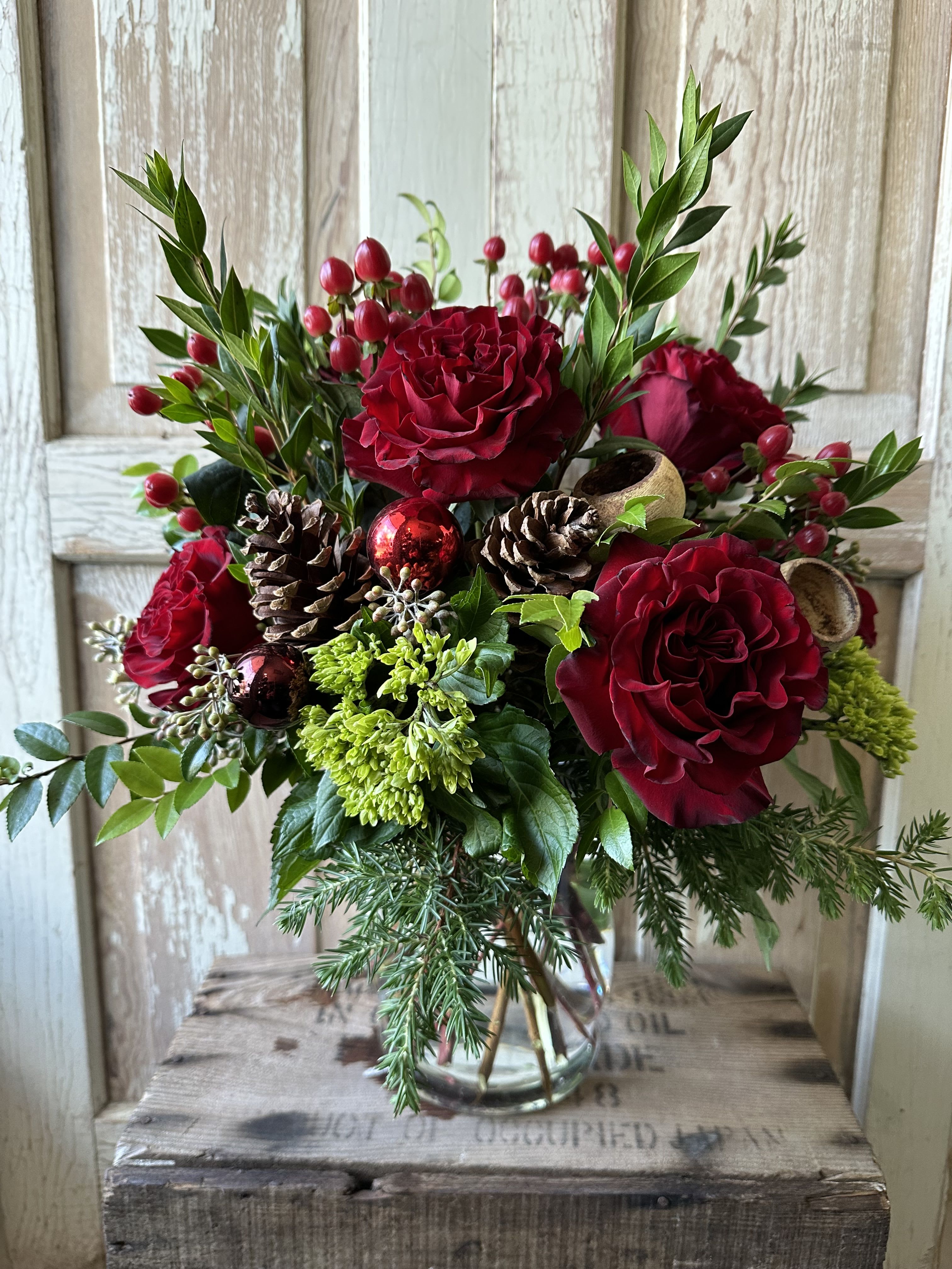 Festive Friday  - Warm up any home with this festive holiday arrangement! Seasonal fragrant greens, roses, hypericum and holiday accents are found in this vase of joy! 