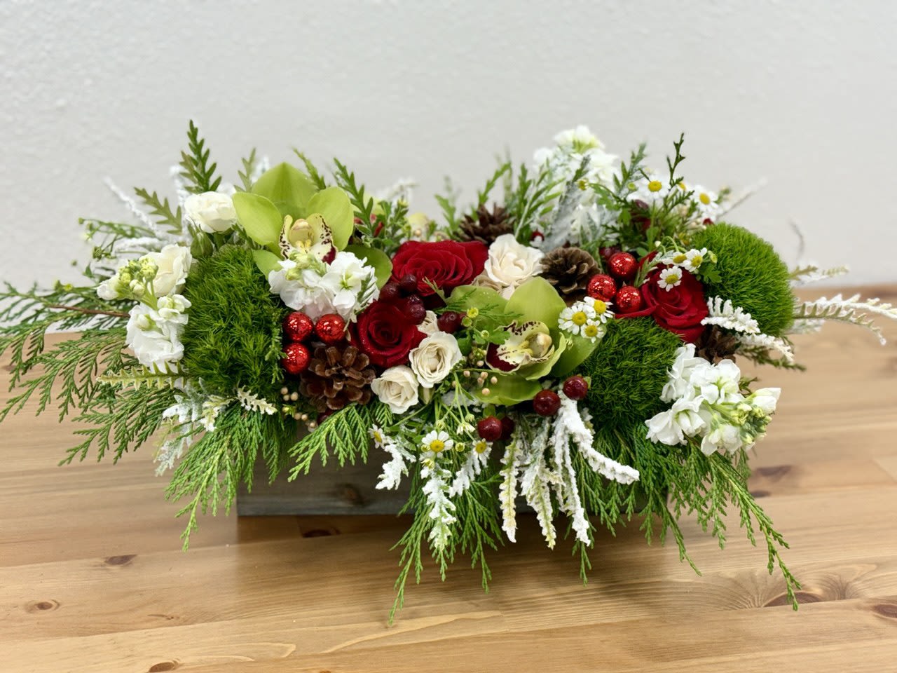 Jingle Bells - &quot;Beautiful Christmas centerpieces crafted in rustic wooden boxes – the perfect gift to celebrate the holiday season with your loved ones. These charming, handcrafted arrangements combine festive greenery, elegant accents, and seasonal touches to create a warm and inviting atmosphere. Whether displayed on a dining table, mantelpiece, or gift-giving table, these wooden box centerpieces are an ideal way to spread holiday cheer and make unforgettable memories with those you cherish most.&quot;  Standard container is 12in Deluxe container is 20in