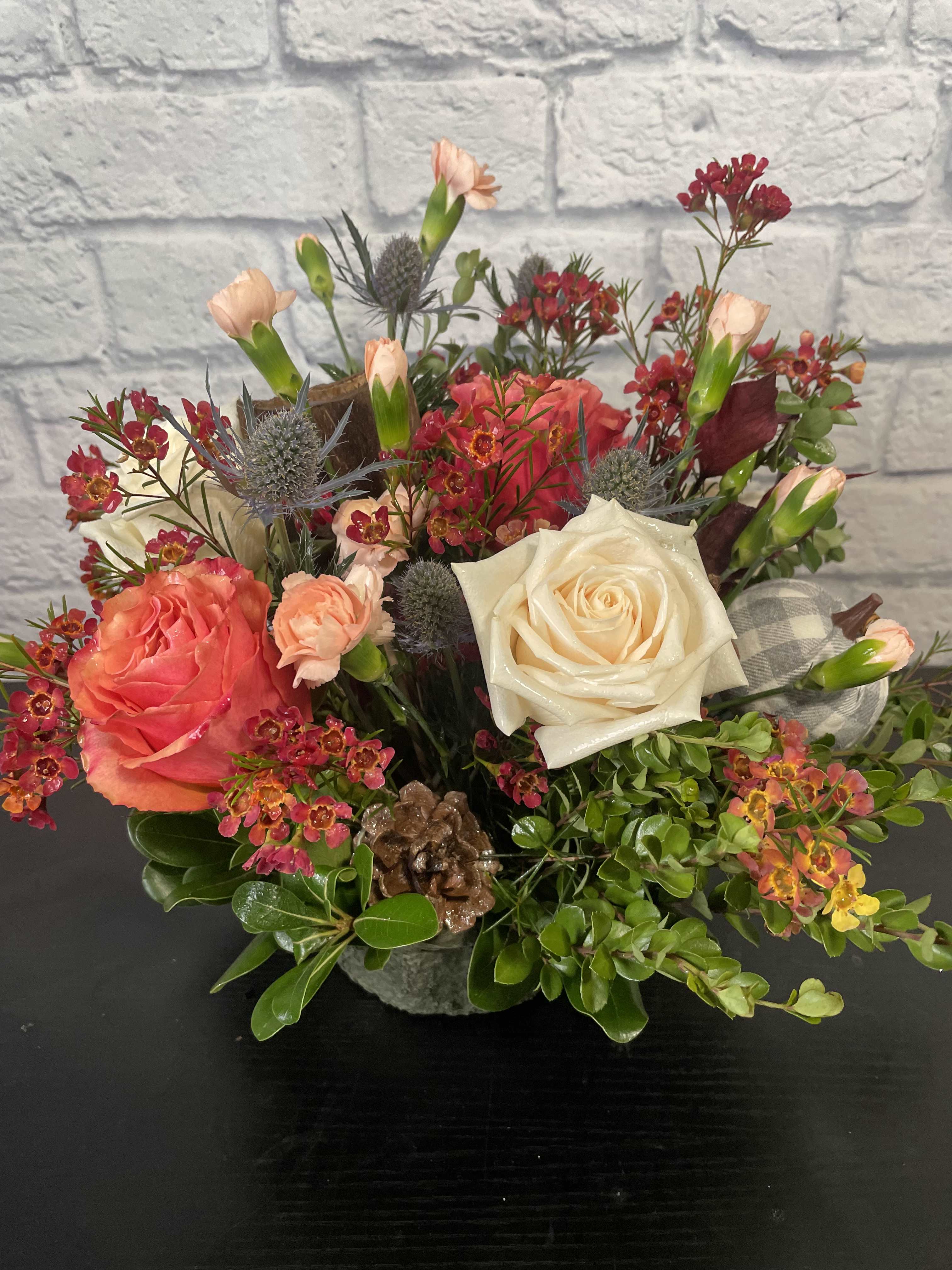 Thanksgiving Centerpiece - We'll design a beautiful fall Thanksgiving Centerpiece for the table.  We have 3 sizes to choose from.  The STANDARD is smaller in size for a smaller table (around 13&quot; x 13&quot; x 16&quot;), DELUXE is our medium regular size for the average table (around 23&quot; x 13&quot; x 18&quot;), and the PREMIUM is for a food table of a larger table or area (around 33&quot; x 13&quot; x 20&quot;).  These are all short in height.  They may come with a candle or without depending on preference and look.  They will come rounded, so all sides will see the flowers.  This will totally impression your hostess or guests this holiday season.