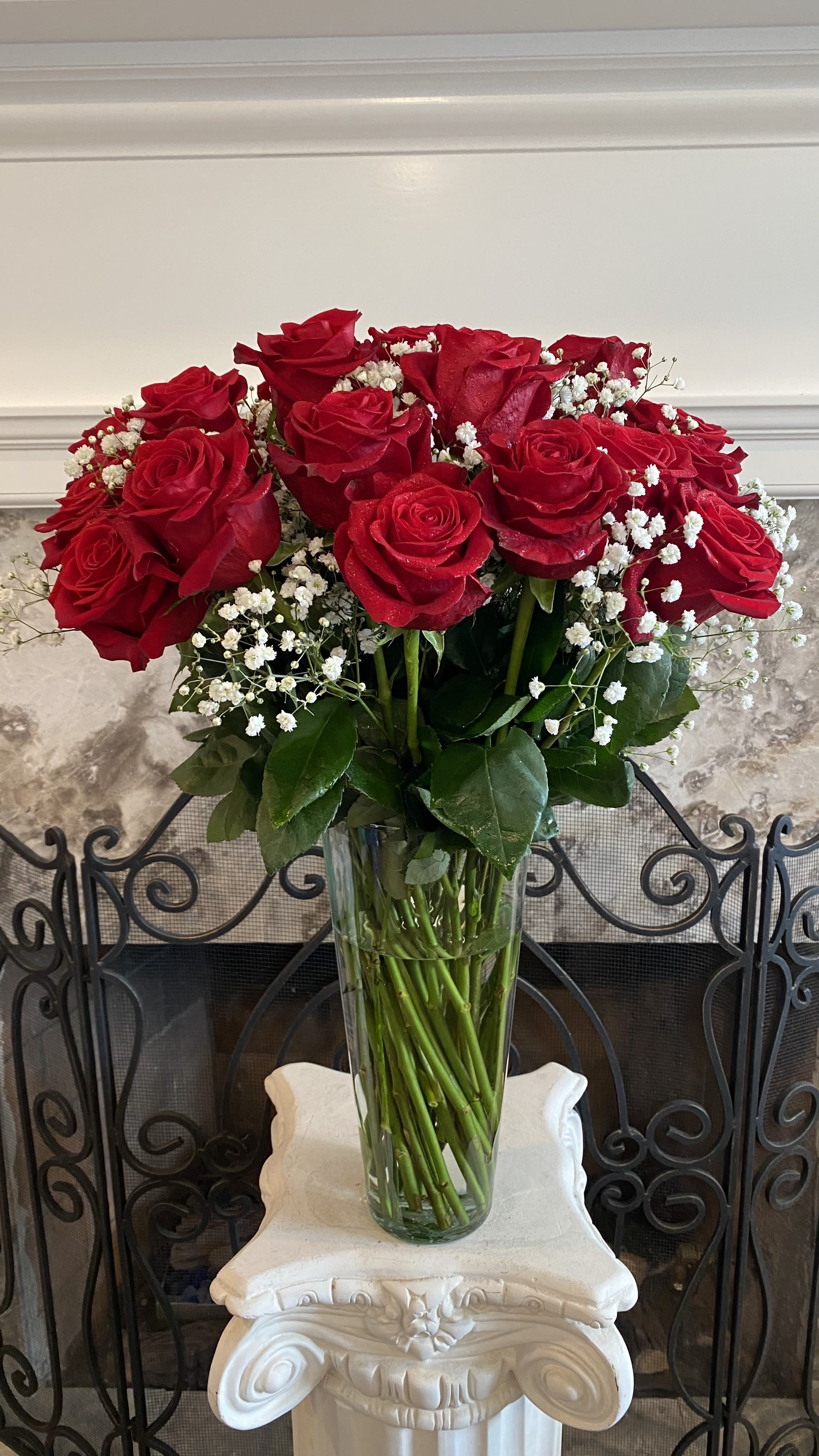 24 Red Rose In A Tall Vase On Promotion - Red roses are timeless, classic and iconic. Whether it's a romantic gesture or a meaningful gift to share how much you care, this bouquet of two dozen roses is bound to make your loved one swoon. Two dozen red roses are about 26&quot; H x 18&quot;W. A farm-fresh bunch of 24 floral stems and foliage. Includes a 12&quot; H clear glass  vase. The shape of the vase may be slightly different, depends available. 