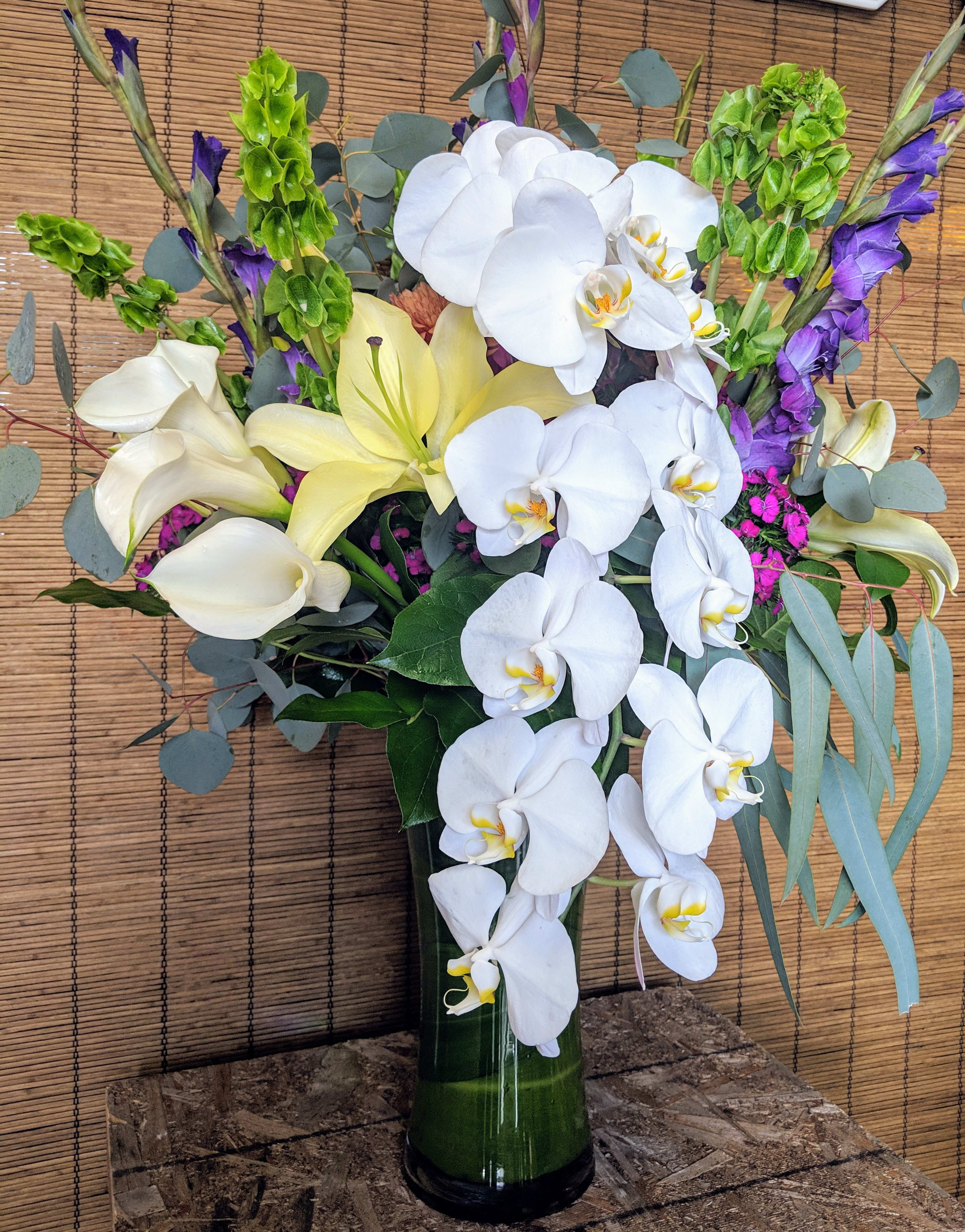 Cascading Orchids - White Phalaenopsis Orchids with  Oriental Lilies, Calla Lilies,  and other complimentary flowers. Each On of A kind !