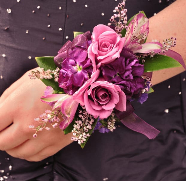 Mulan Wrist Corsage - Lavender Roses, Alstroemerias, Stock and Heather with sheer purple lace ribbon. Deluxe choice includes more flowers. Premium choice includes more flowers and fairy lights for a beautiful glow.