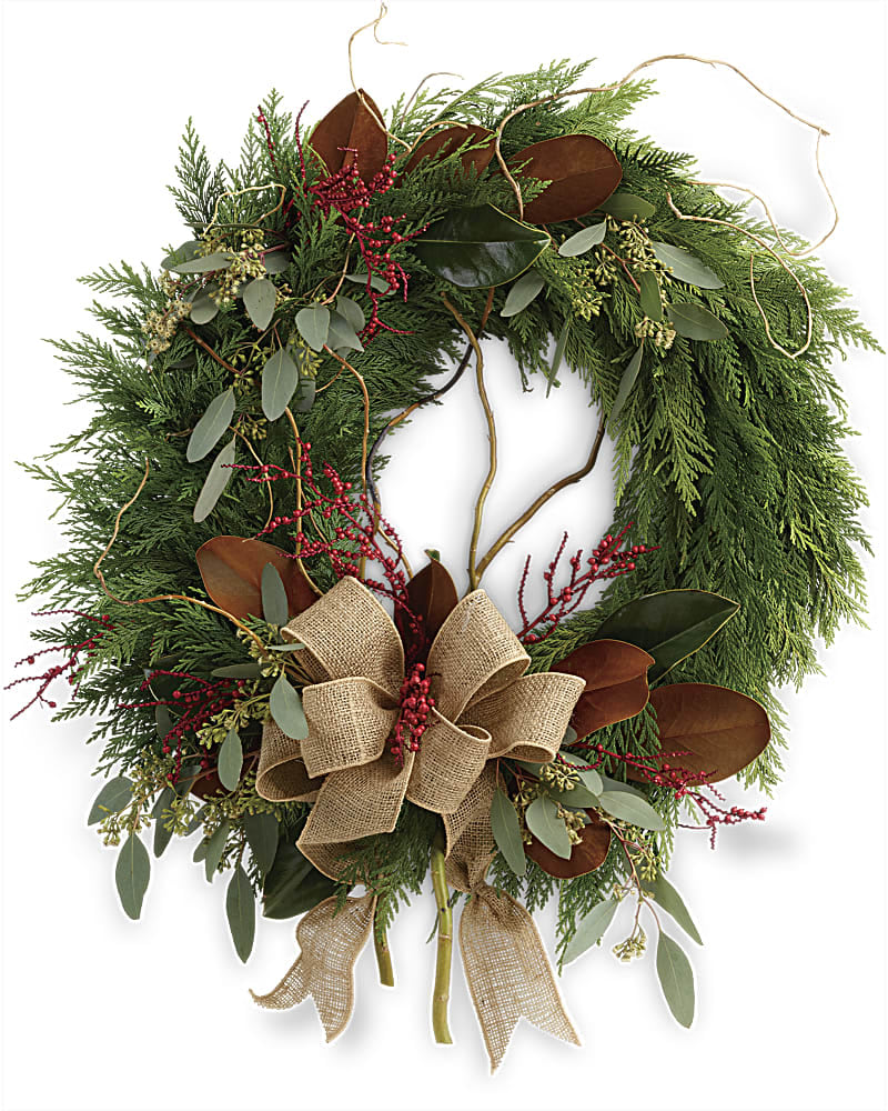 Rustic Holiday Wreath - Capture the rustic beauty of the winter forest with this wondrous flat cedar wreath dressed up for the holidays with burlap ribbon and a spray of red Christmas berries! This wondrous wreath includes flat cedar curly willow seeded eucalyptus and magnolia leaves.