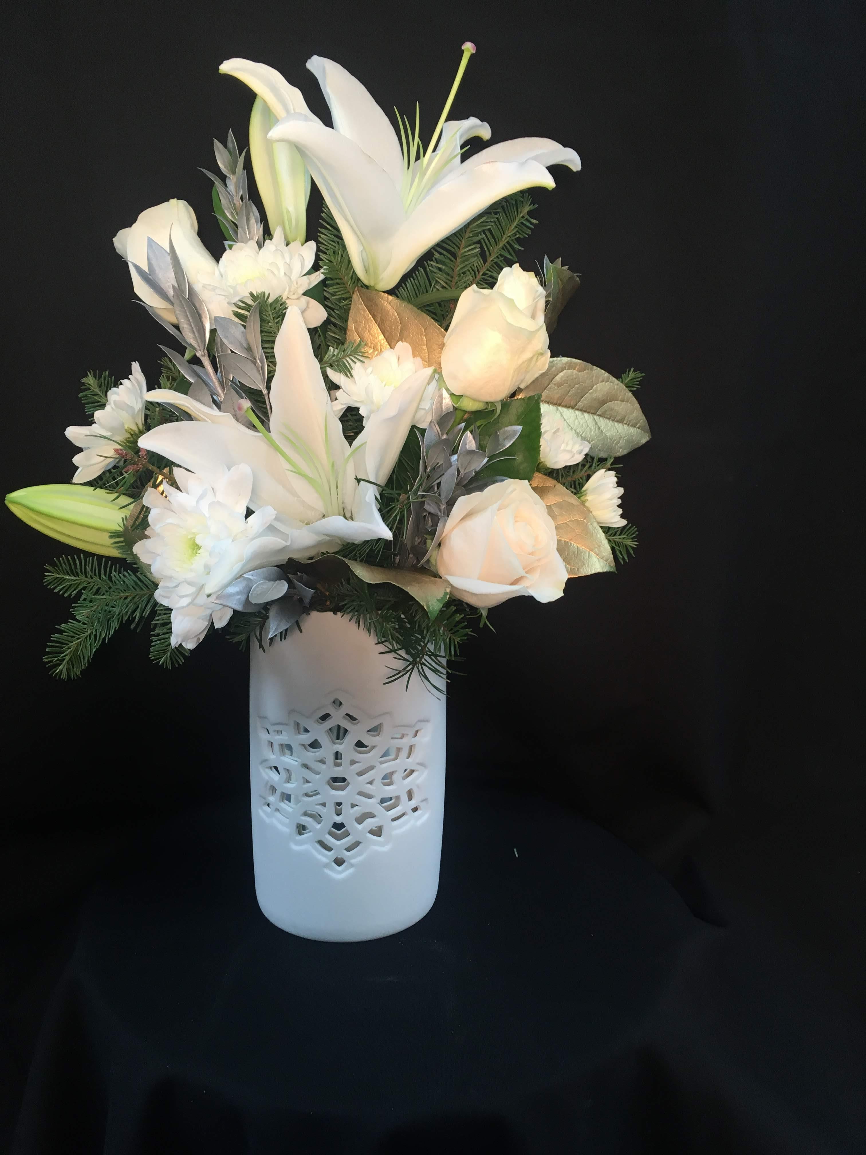 White cloud - white flowers in a white cylinder ceramic  stargazers, roses crysantemums, christmas greens and gold lemon leaves