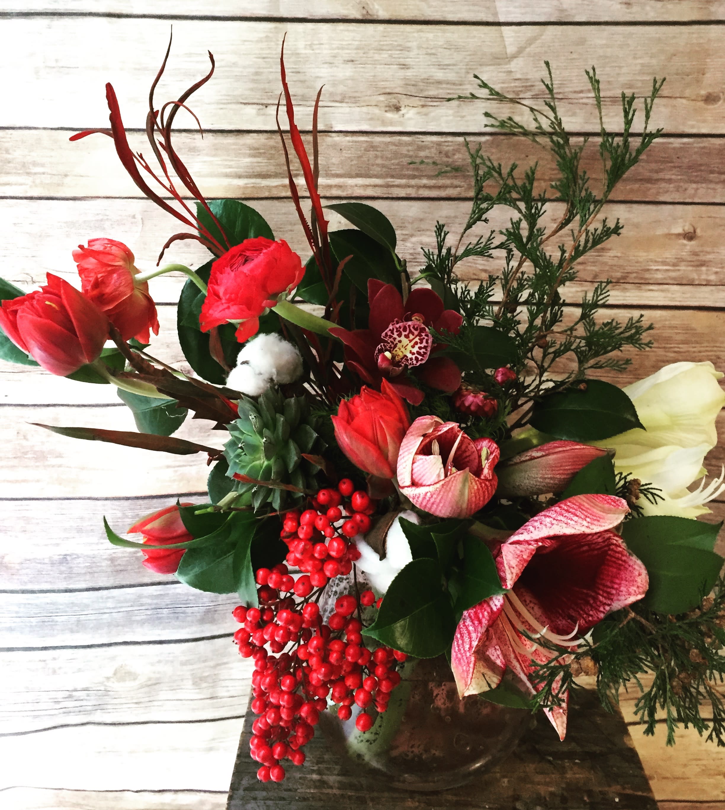 Deck the Halls - Holiday amaryllis with seasonal berries and evergreens. A funky holiday design perfect to send to that cool new yorker! Send the best flowers from the best flower shop in New York. We offer same day flower delivery in Manhattan, Queens, Bronx, Brooklyn, Staten Island and West Chester counties. We have the prettiest and most luxurious flowers to choose from and our designs are unique and whimsical. We carry Peonies almost every day of the year!!