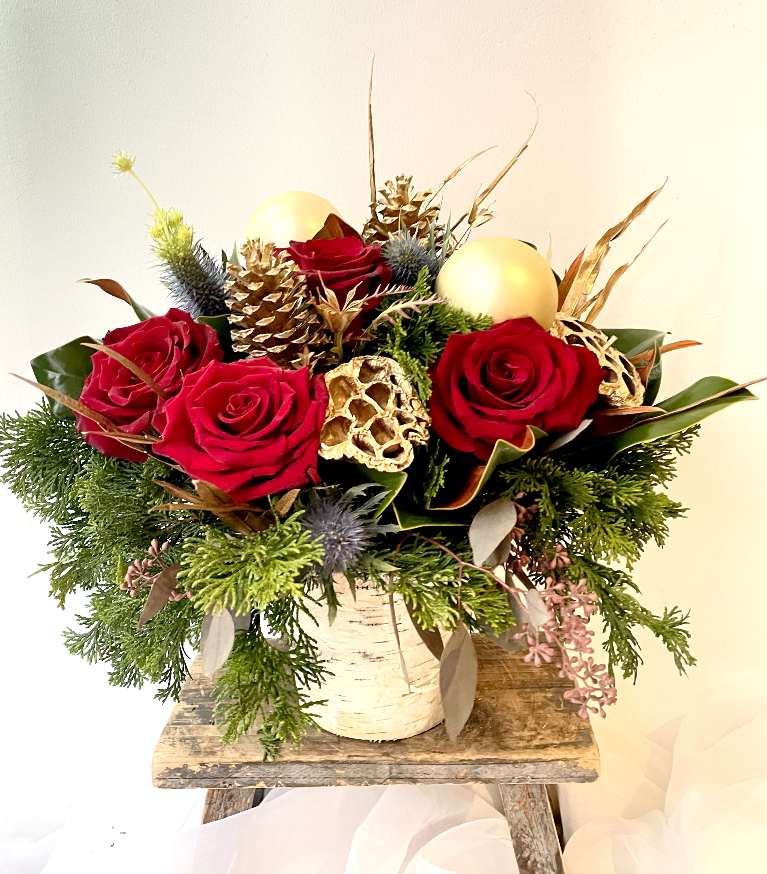 Merry and Bright - Birch vase filled with holiday greens, red roses, thistle and pinecones. Happy Holidays! Send some christmas cheer this holiday season. Send the best flowers from the best flower shop in New York. We offer guaranteed same day flower delivery in Manhattan, Queens, Bronx, Brooklyn, Staten Island and West Chester counties. We have the prettiest and most luxurious flowers to choose from and our designs are unique and whimsical. We carry Peonies almost every day of the year!! Send flowers today.  